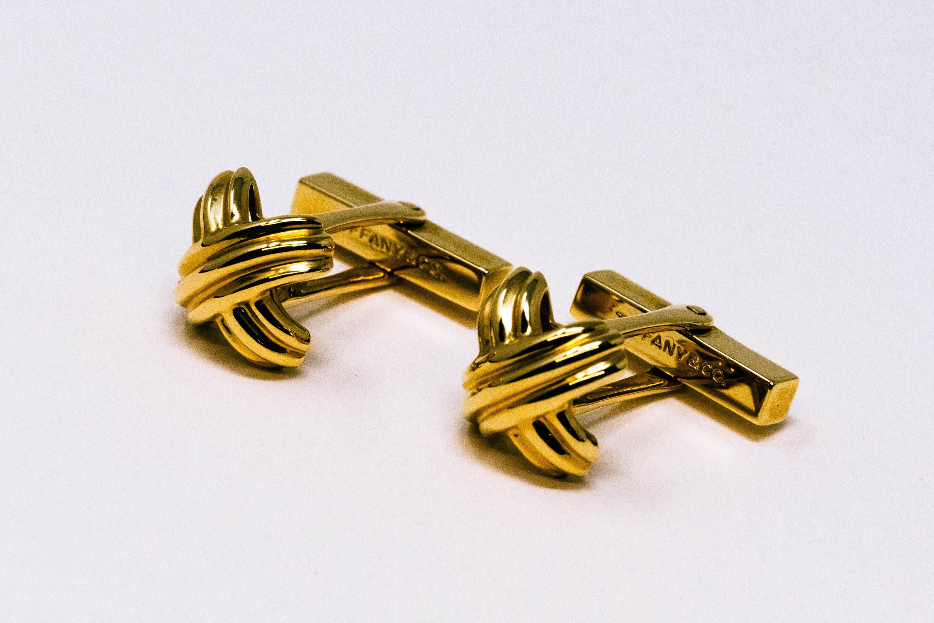 Pair of Tiffany & Co. 18k gold Signature X cufflinks. Fully marked 750, circa 1992. Comes with the box, measures 1 1/4 inches long with bar extended, face is 1/2 inch x 1/2 inch.