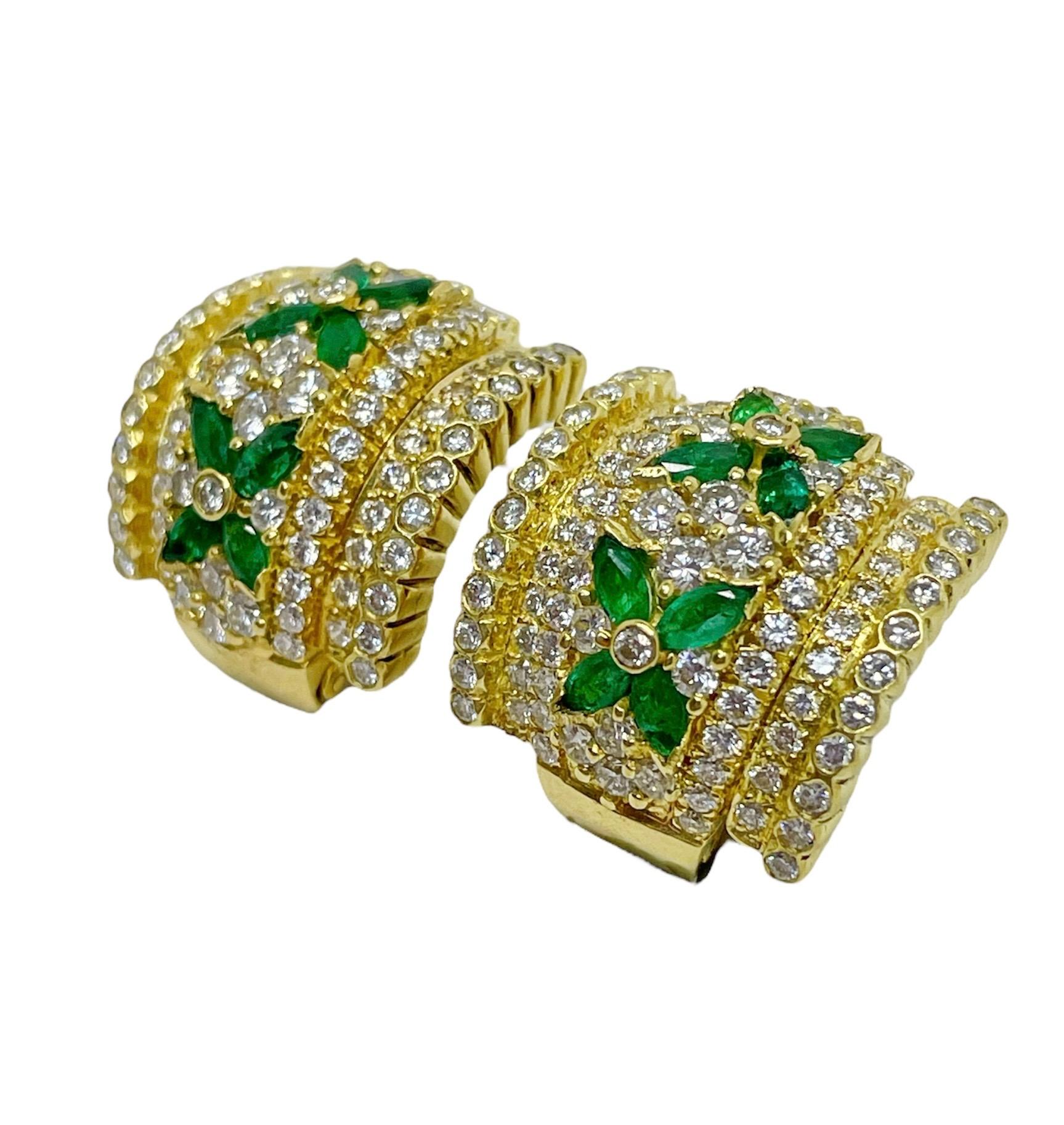 These gorgeously classic earrings by Tiffany & Co. contain 184 round brilliant cut diamonds weighing approximately 3.50 carats total with eight marquise cut emeralds in a floral motif. Mounted in 18 karat yellow gold and skillfully crafted, these