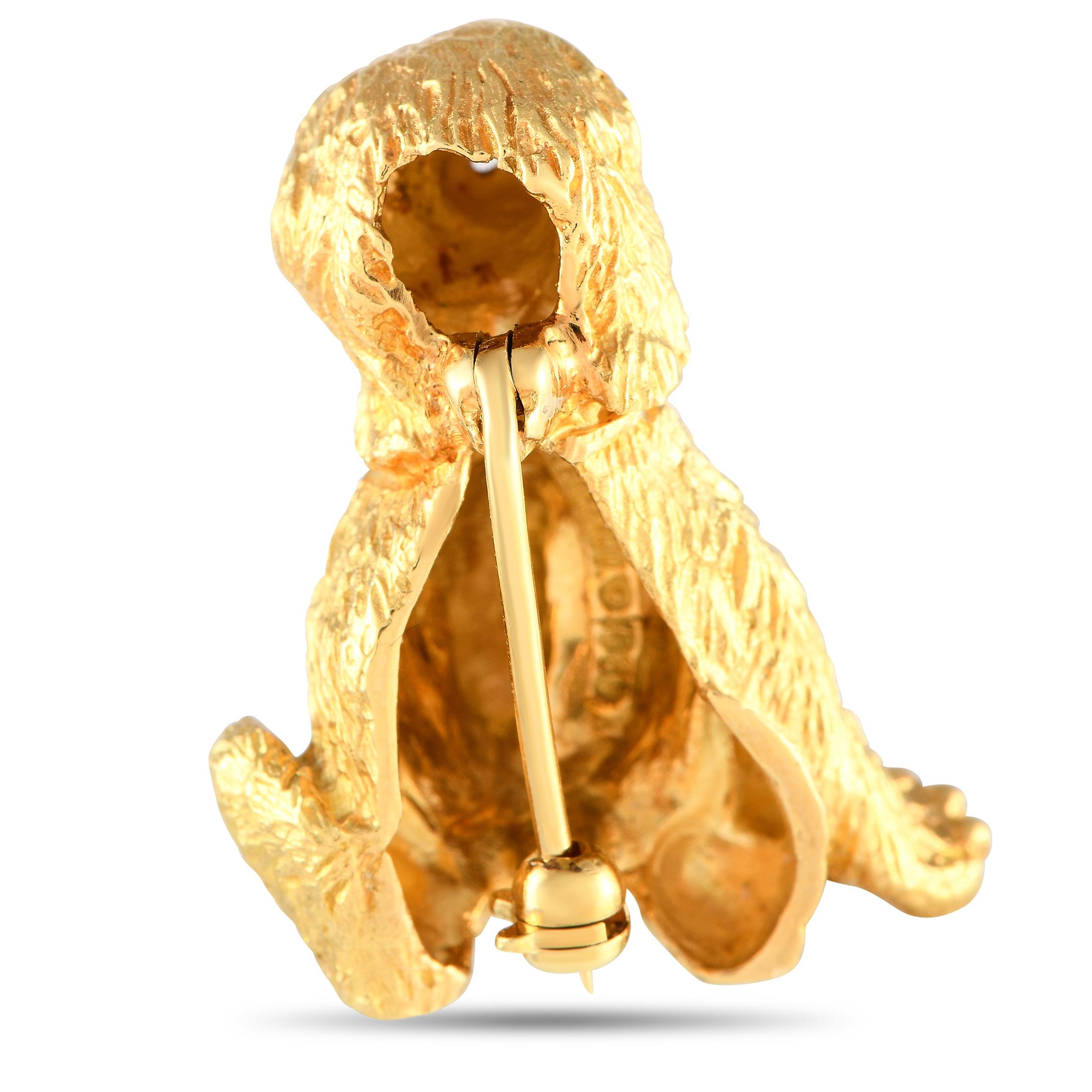 It doesnt get any more adorable than this exquisitely crafted Tiffany & Co. dog brooch. Perfect for any dog lover, this opulent accessory is crafted from 18K Yellow Gold and measures 1.0 long by 0.75 wide. Diamond and Sapphire accents provide the