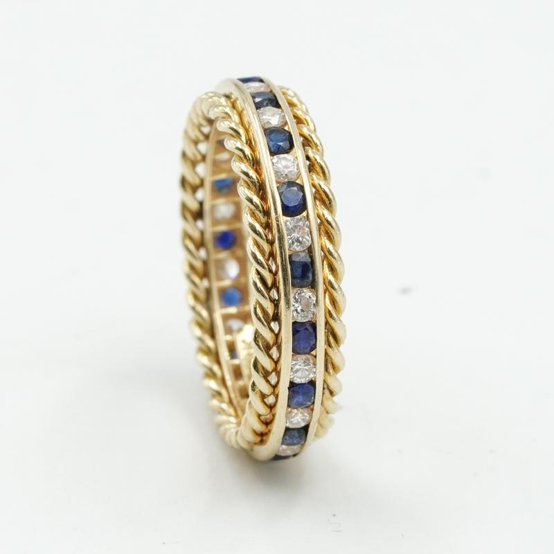 This Tiffany & Co. Diamond and Sapphire ring adds an easy to wear pop-of-color to your collection. The piece can be worn as a stand alone ring, or be added to a stack. The eternity band features channel set, round cut Diamonds and Sapphires