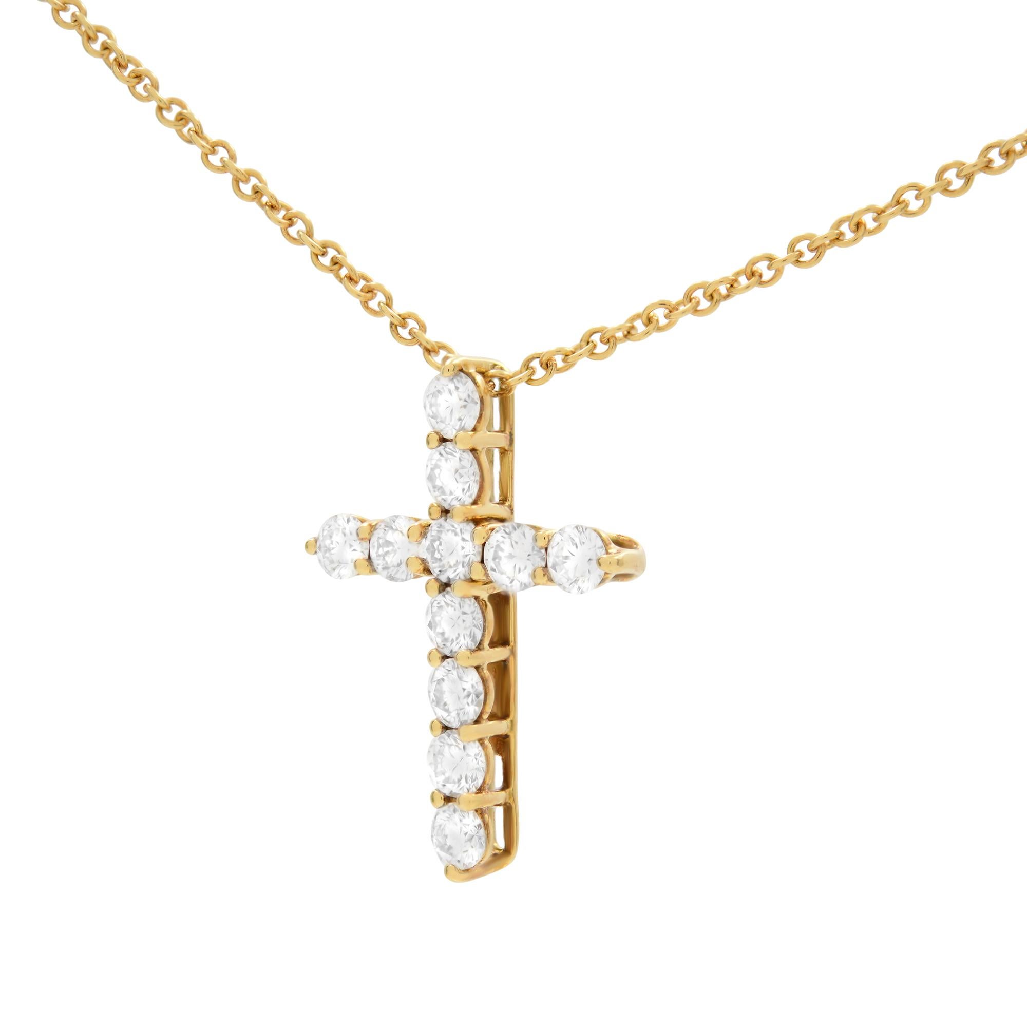 18K yellow gold diamond cross pendant from Tiffany & Co. The cross is prong set with 11 round cut diamonds. Total carat weight 0.42. Cross size: 17mm x 12 mm. Thickness: 3.00 mm. Chain Length: 16 inches. Excellent pre-owned condition. Comes with
