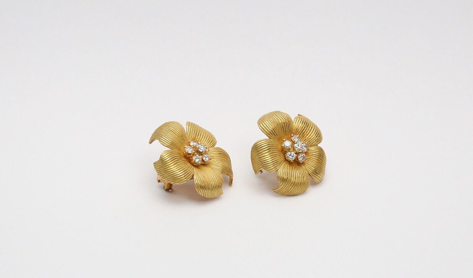 These elegant Tiffany & Co. earrings are a stunning example of beauty and nature. Crafted from high quality 18k yellow gold, they feature a charming dogwood flower design with sparkling round diamonds in the center. The earrings weigh 18.3 grams and