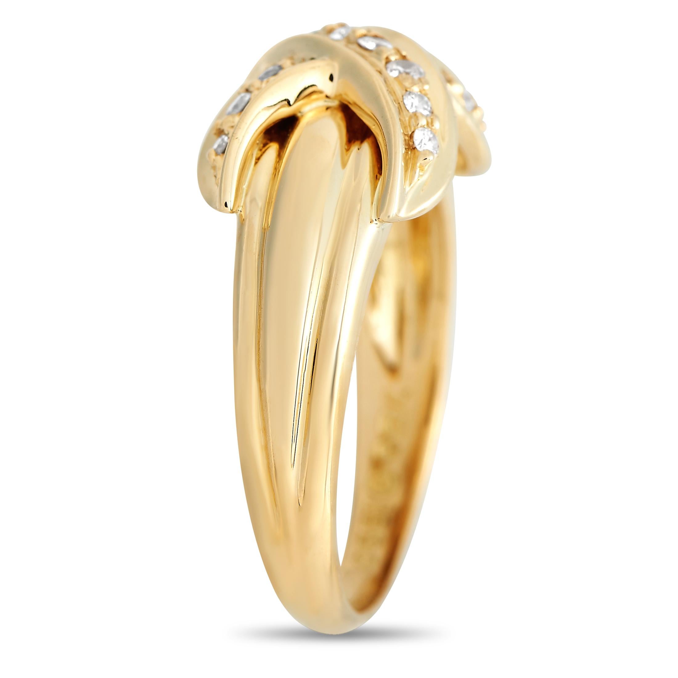 A timeless Tiffany & Co. ring that you can seamlessly integrate into any outfit. The yellow gold band tapers at the bottom and features a fluted detail on top. A diamond-encrusted X motif embraces the ridged part of the shank and wraps the ring with