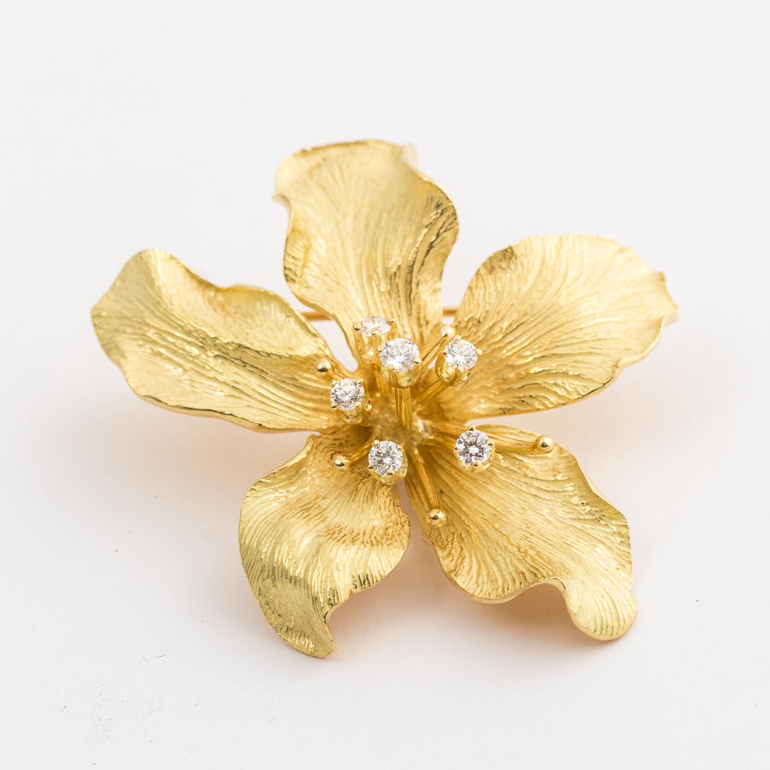 Made by Tiffany & Co, the details on this brooch are meticulous as well as sculptural. Composed of solid yellow gold, the piece weighs 17.8 grams. There are 5 brilliant diamonds, measure 2.2 - 2.8 points with a total estimated 28 points. The brooch