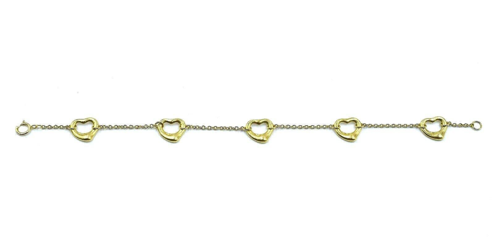 One of Elsa Peretti's most celebrated and iconic pieces from Tiffany & Co., this gorgeous Open Heart bracelet wraps your wrist in a lovely and chic way. The bracelet features five open heart charms that are attached by a delicate 18k yellow gold