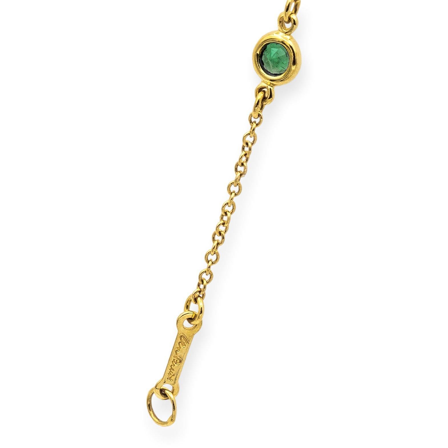 Tiffany & Co. Bezel Bracelet from the Color by the Yard collection, designed by Elsa Peretti. Crafted in 18K yellow gold, the bracelet features five exquisite round deep green emeralds, each set in delicate bezels, totaling 0.40 carats. Measuring 7