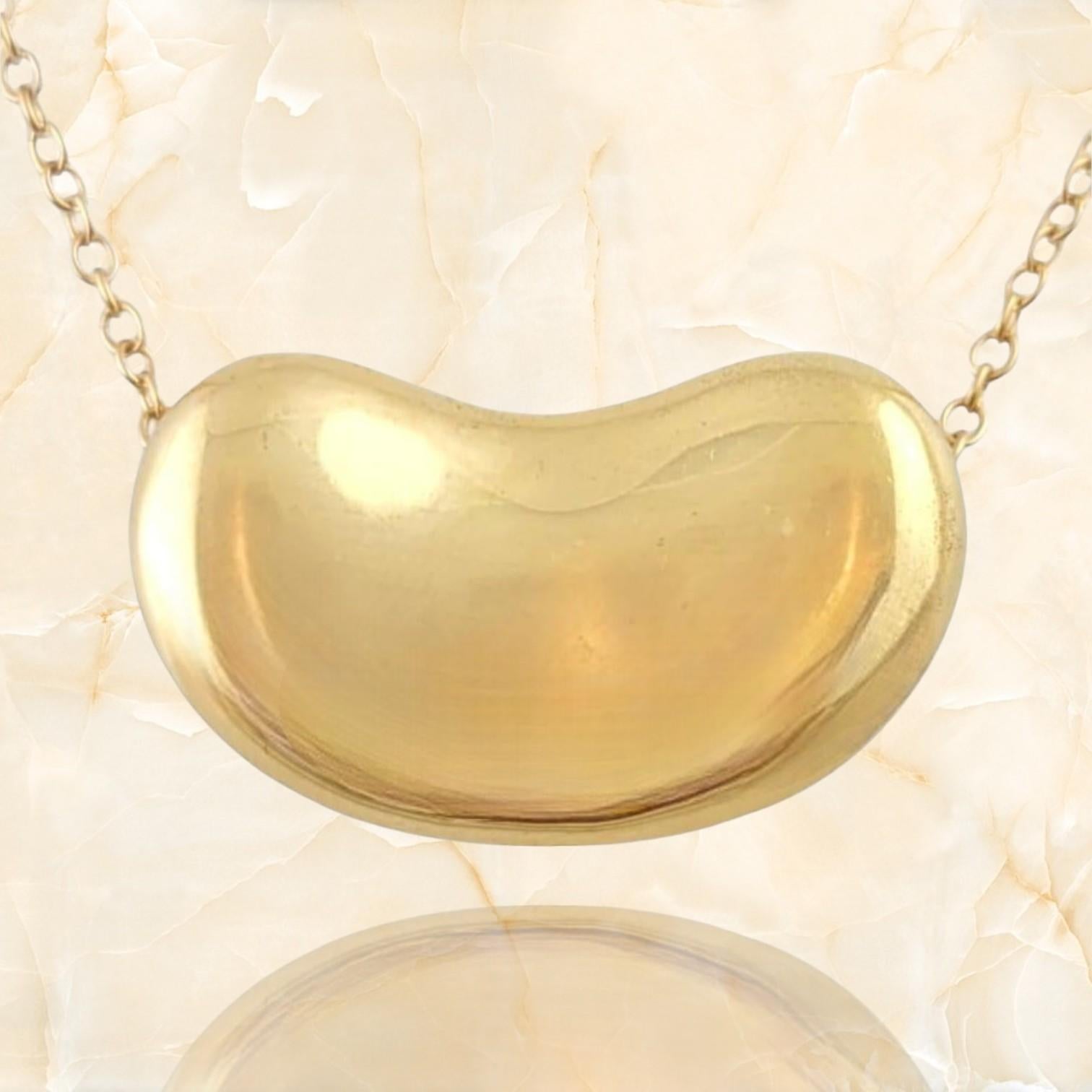 Embrace iconic design with this Tiffany & Co. 18K Yellow Gold Elsa Peretti Kidney Bean Necklace. Featuring a 20 mm kidney bean pendant crafted in luxurious 18K yellow gold, this necklace is a perfect blend of elegance and simplicity. Designed by