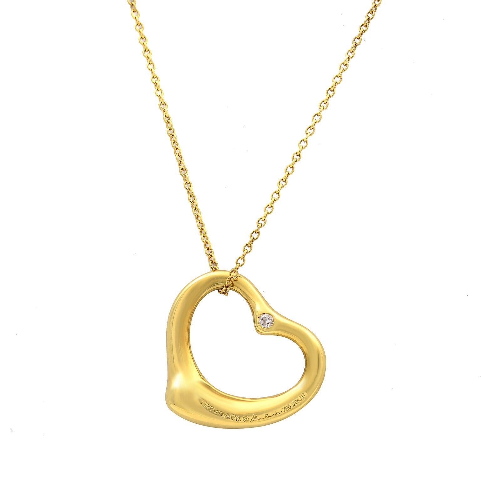 Tiffany and Co. diamond and 18K yellow gold necklace from he Elsa Peretti Open Heart collection. This 24.4 inch long necklace features 8 grams of 18 karat yellow gold. Two bezel set diamonds adorn the top of the heart pendant, one set on each side.