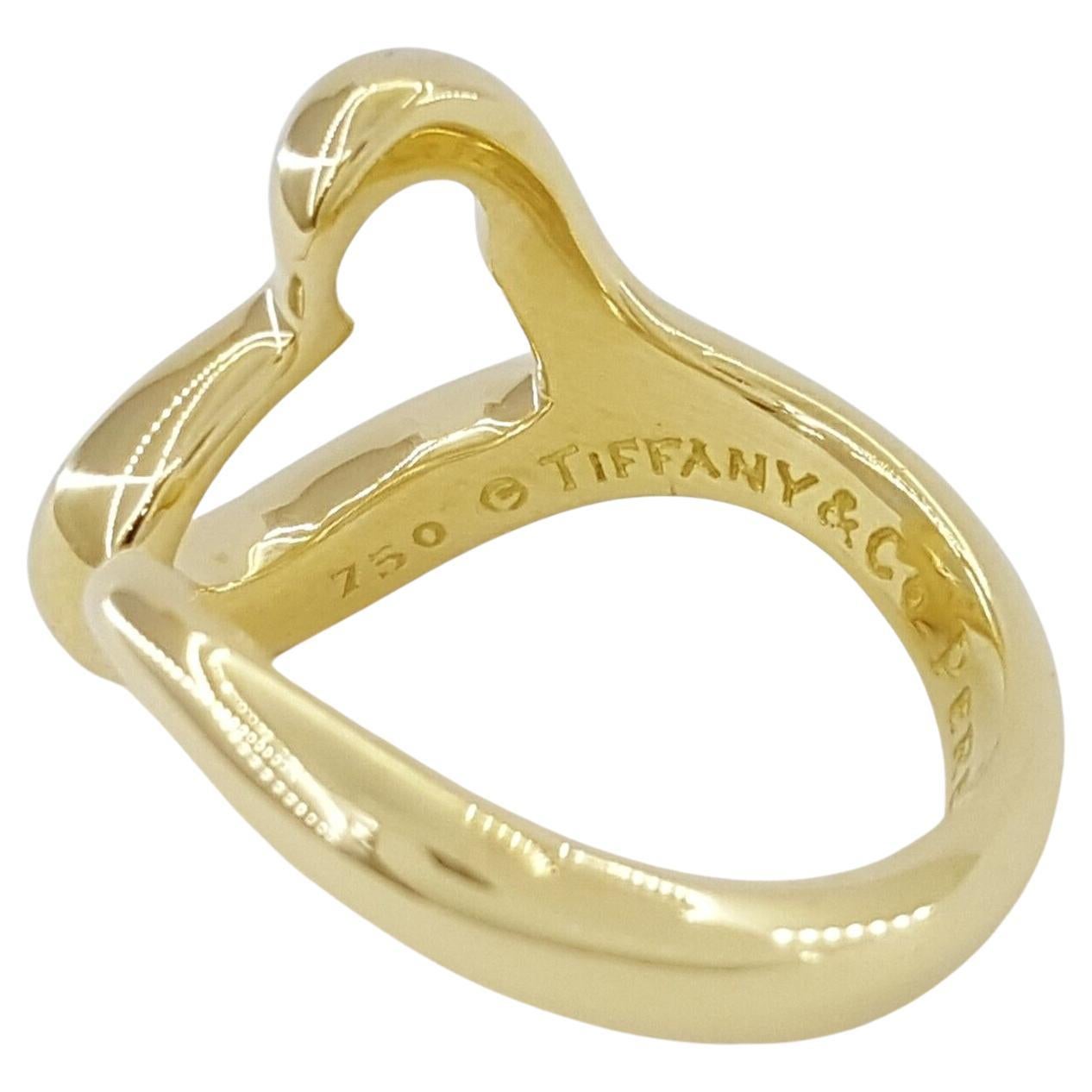 Tiffany & Co. 18K Yellow Gold Elsa Peretti Open Heart Ring is a charming and elegant piece of jewelry from the renowned luxury brand. Here's what you need to know about it:

Material: Crafted from high-quality 18K yellow gold, this ring exudes