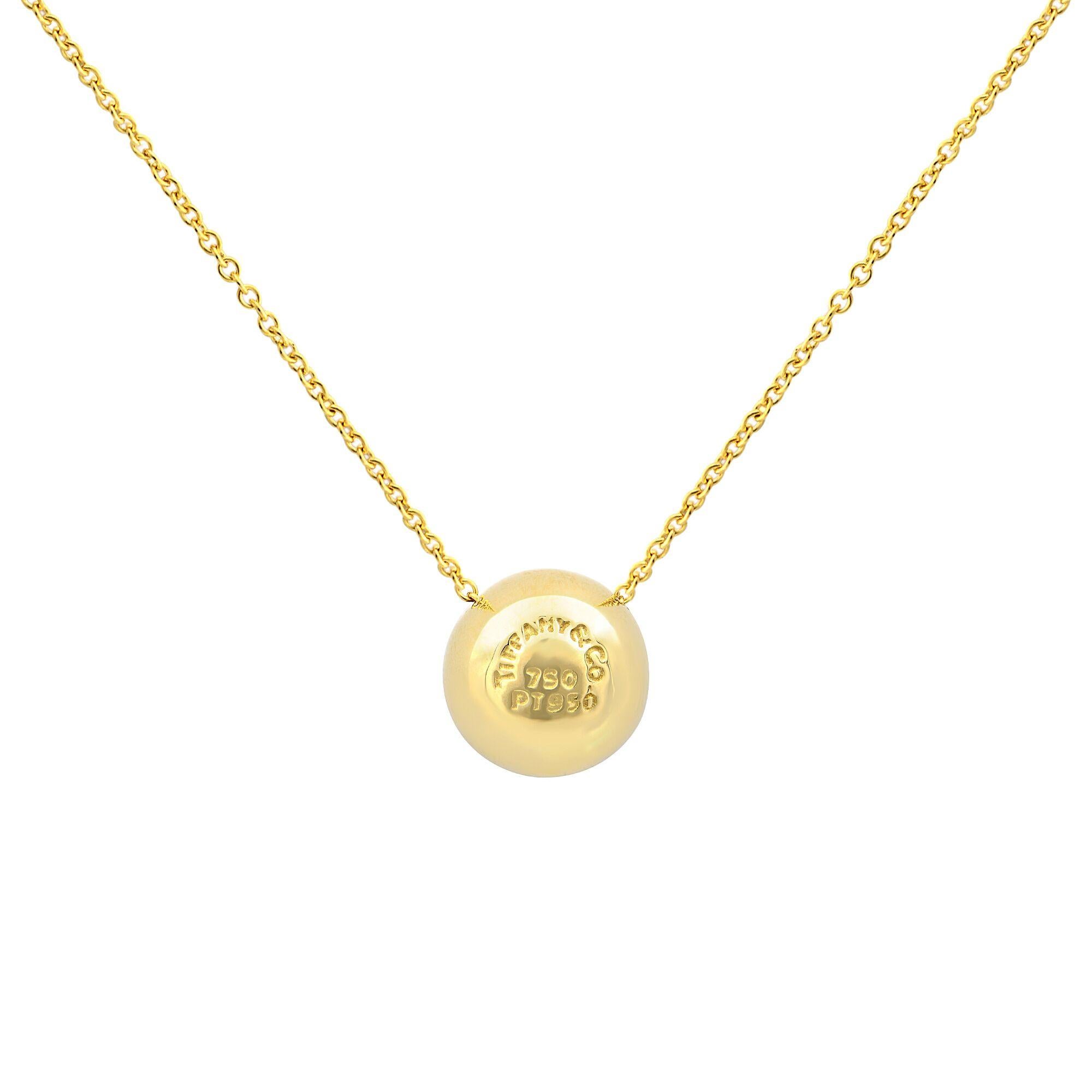 Tiffany & Co. diamond ball pendant, finely crafted from solid 18k yellow gold and platinum. It comes from Tiffany's ever so popular Etoile collection and looks stunning on the neck. It is fully signed with Tiffany & Co. and the gold content.