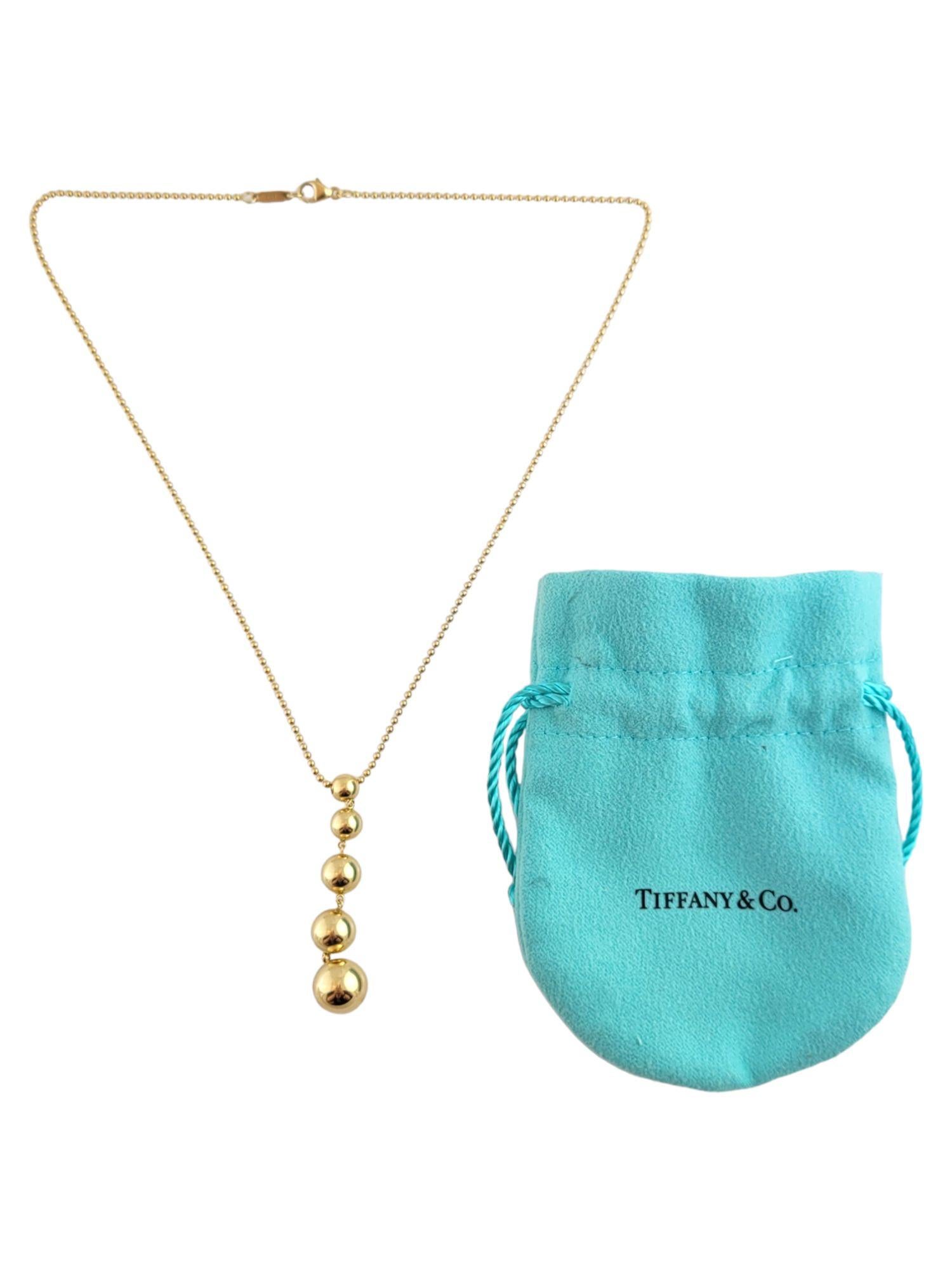 This gorgeous, graduated bead drop necklace by Tiffany & Co is crafted from 18K yellow gold!

Size: 49.3mm X 10.3mm X 10.3mm

Chain Length: 16 1/4