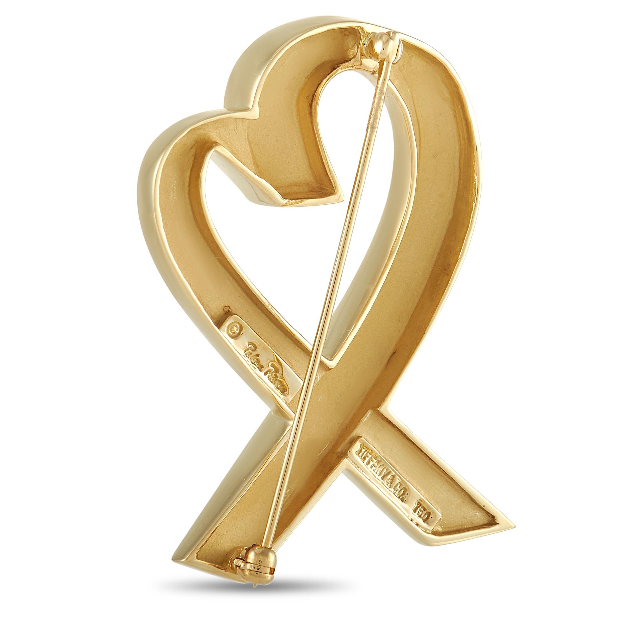 Undeniably charming, this luxurious brooch from Tiffany & Co. is an exquisite addition to any ensemble. Pin closure at the back makes this 18K Yellow Gold heart-shaped design incredibly versatile. This lustrous accessory measures 1.75” long and