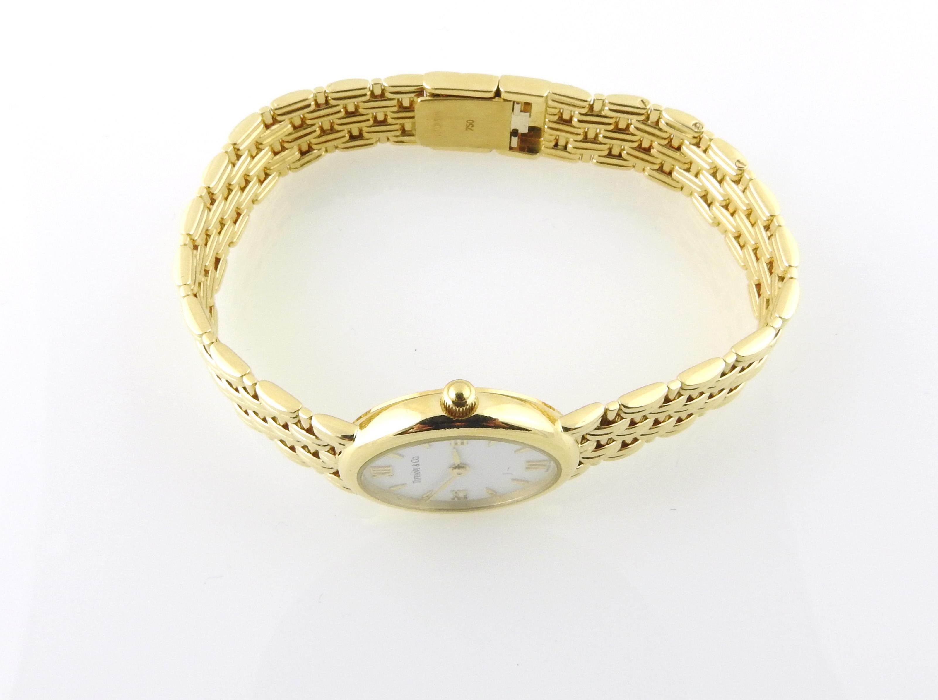 Tiffany & Co. 18K Yellow Gold Ladies Watch

This classic ladies Tiffany watch is set in elegant 18K yellow Gold

Oval case is approx. 22.5 mm x 19.5mm

18K yellow gold band is in a basket weave design - fits up to 6 1/4
