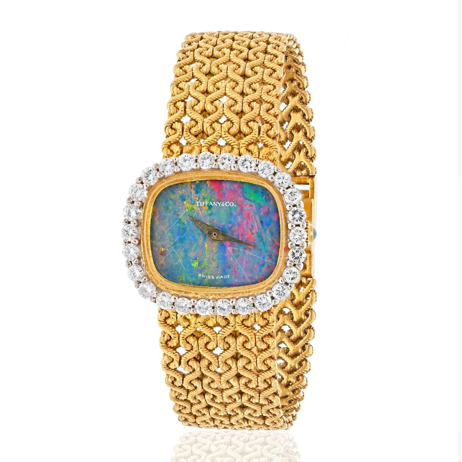 Quartz movement, opal dial and crown, round diamonds, 18k yellow gold, signed Tiffany & Co., Swiss made, Germany, numbered

Size/Dimensions: case 23.35 mm, 15.5 cm (61/8 in)
Gross Weight: 43.7 grams

Movement runs and sets as it should. Service is