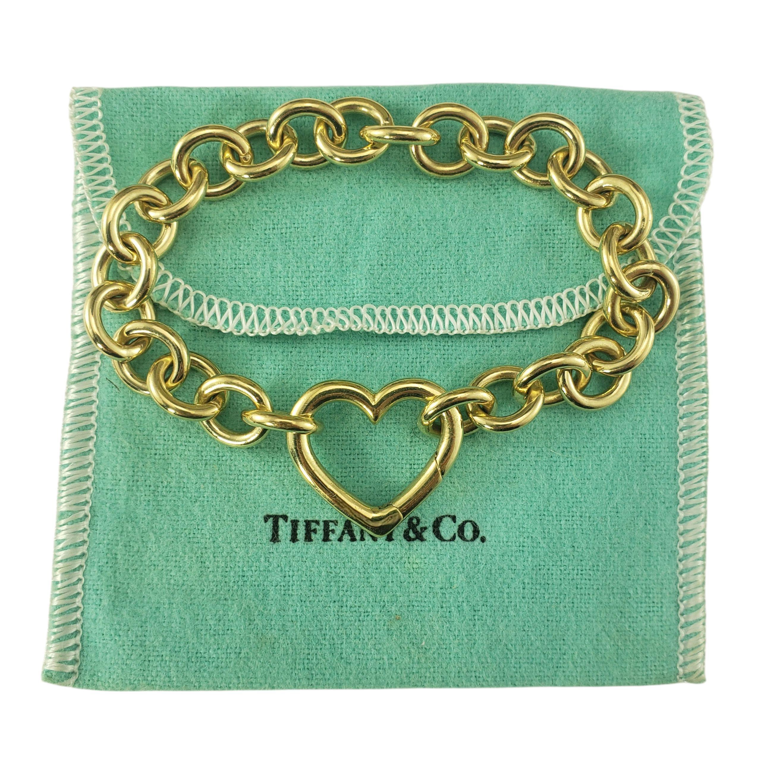 Tiffany & Co. 18K Yellow Gold Open Heart Link Bracelet w/Pouch-

Elegant and iconic, this stunning open heart bracelet is crafted in meticulously detailed 18K yellow gold. The heart detail serves a both a functional closure and the centerpiece of