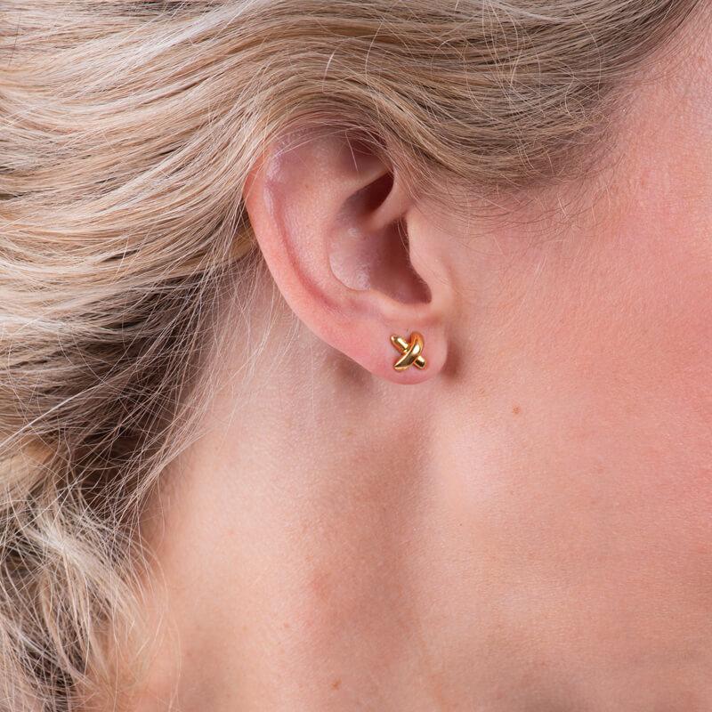 An everyday earring crafted from 18 karat yellow gold, these feature Paloma Picasso's handwriting in the shape of an X. The X symbol is universal for a kiss and these earrings were inspired by New York City graffiti.  
Condition: Excellent. No