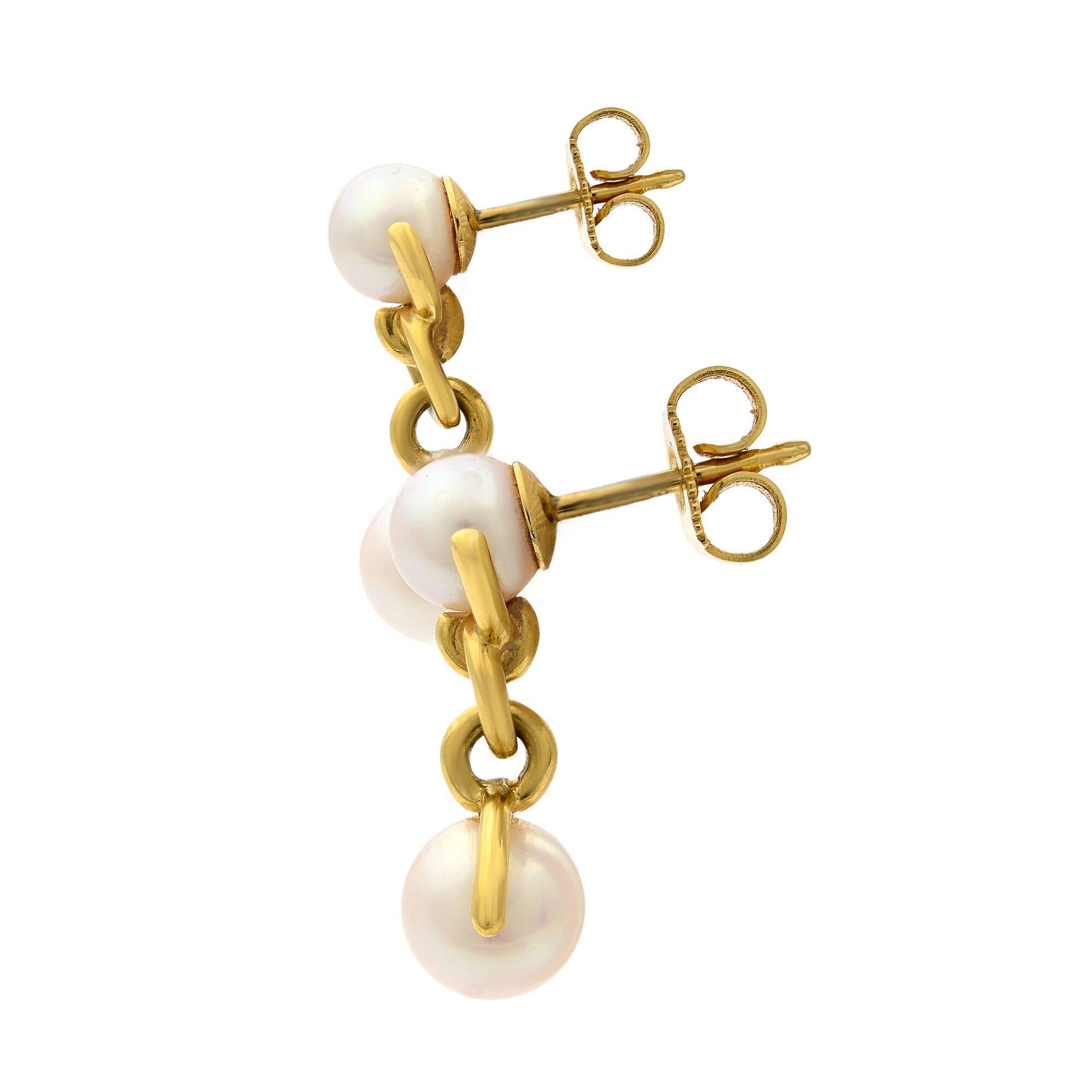 Beautiful Tiffany & Co. 18K yellow gold drop earrings featuring cultured pearls and clutch back closures. Both earrings stamped T&CO 750 and closure backs also stamped T&CO 750. Each earring is 19mm long. Condition is pre-owned but looks great.