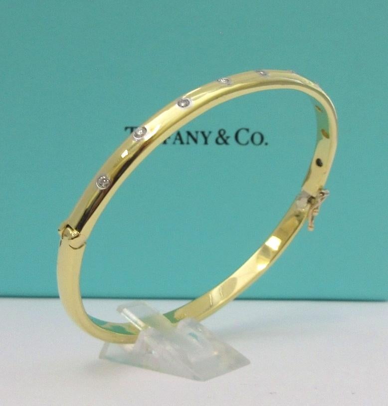 TIFFANY & Co. 18K Yellow Gold Platinum Diamond Etoile Bangle Bracelet

Metal: 18K Yellow Gold, and platinum(around the diamonds)
Weight: 22.30 grams
Size: Medium size, fits wrists up to 6.25