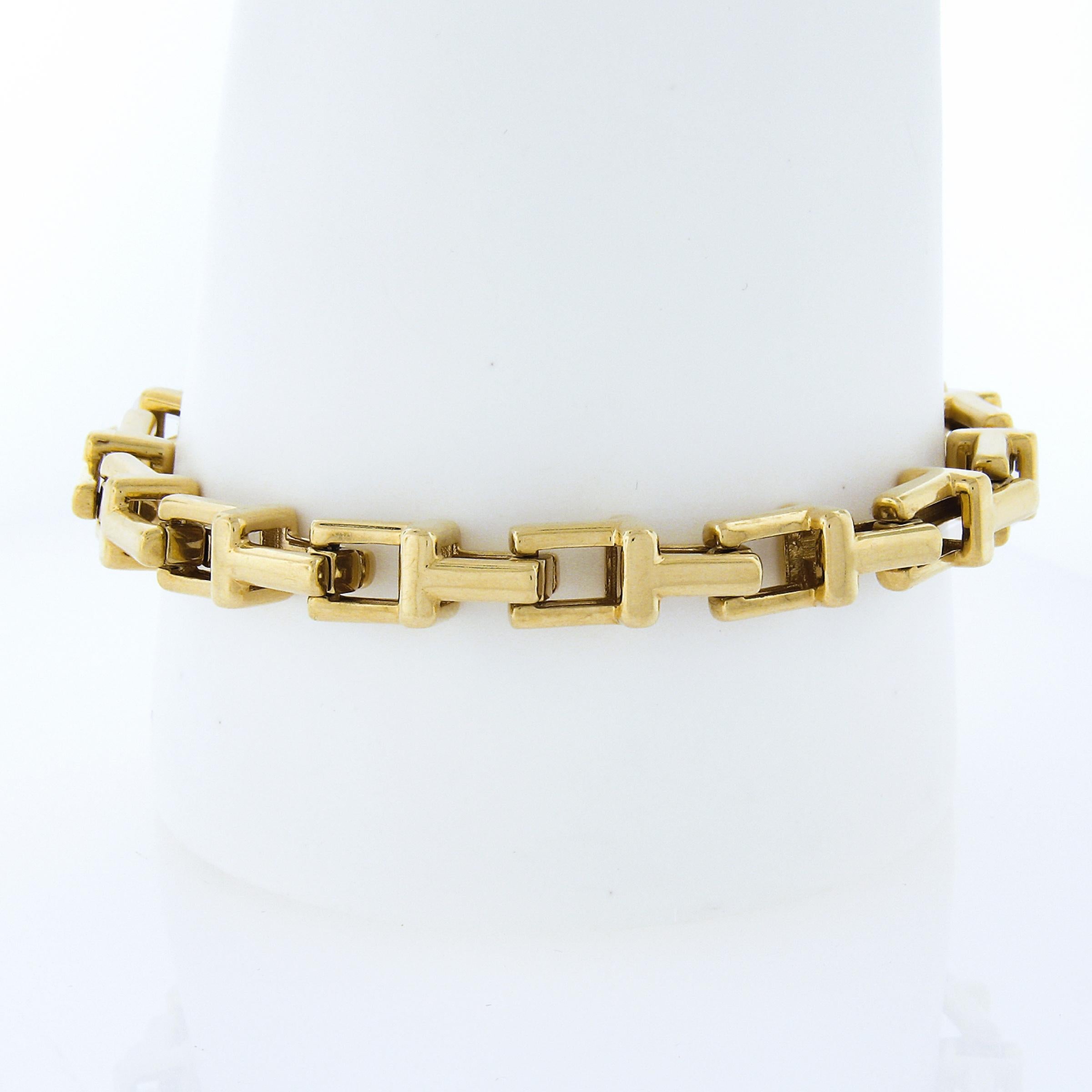 This stunning and bold Tiffany & Co. chain bracelet is crafted in solid 18k yellow gold. This rare 7mm wide bracelet features the iconic T link design that interlocks and flows smoothly throughout. An absolute statement piece from Tiffany & Co. that