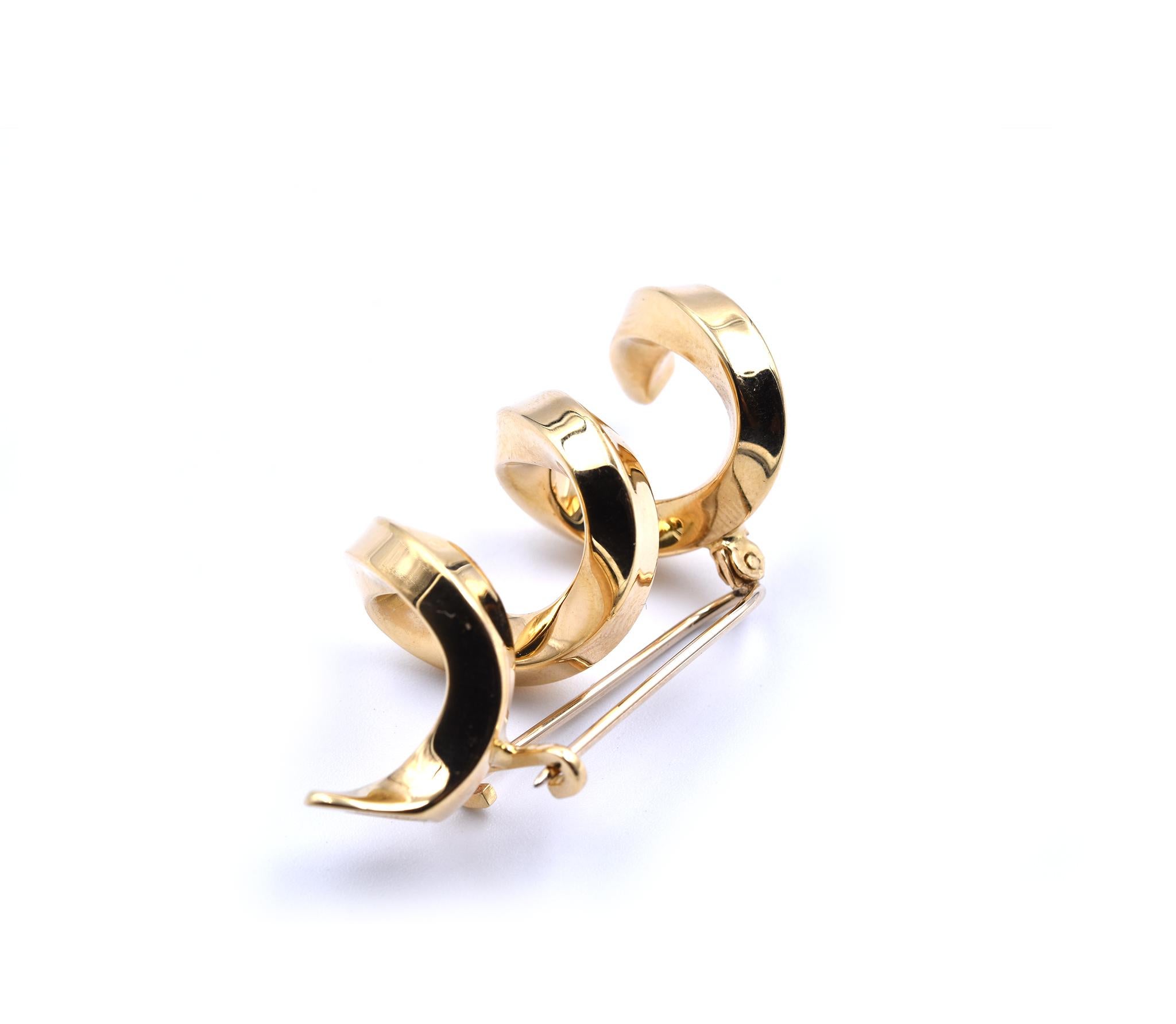 Designer: Tiffany & Co. 
Material: 18k yellow gold
Dimensions: pin is 1 ¾-inch long and 20mm wide
Weight: 13.53 grams
