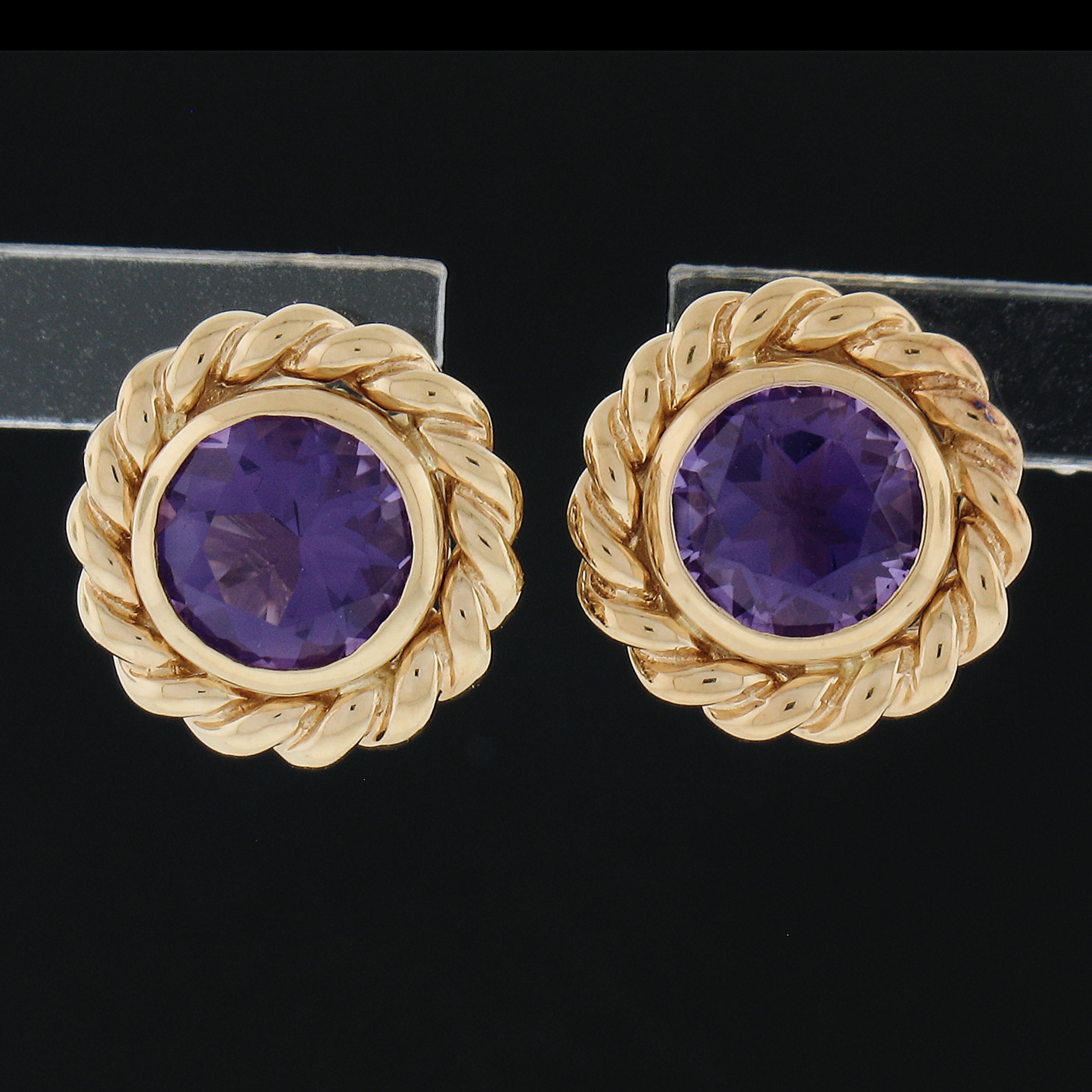 --Stone(s):--
(2) Natural Genuine Amethysts - Round Brilliant Cut - Bezel Set - Very Nice Quality - Purple Color - 5.5mm (approx.)

Material: Solid 18k Yellow Gold
Weight: 4.46 Grams
Backing: Post Backs w/ Butterfly Closures (Pierced ears are