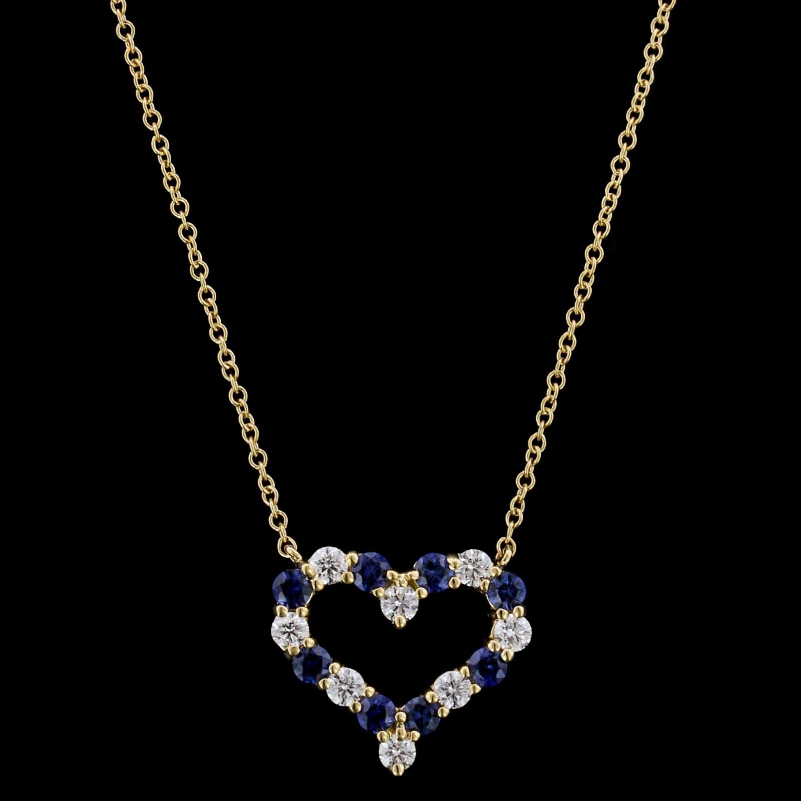 Tiffany & Co. 18K Yellow Gold Sapphire and Diamond Heart Pendant. The pendant is
set with eight round cut sapphires, approx. total wt. .55cts., and eight full
cut diamonds, approx. total wt. .36cts., F color, VS clarity, length 17