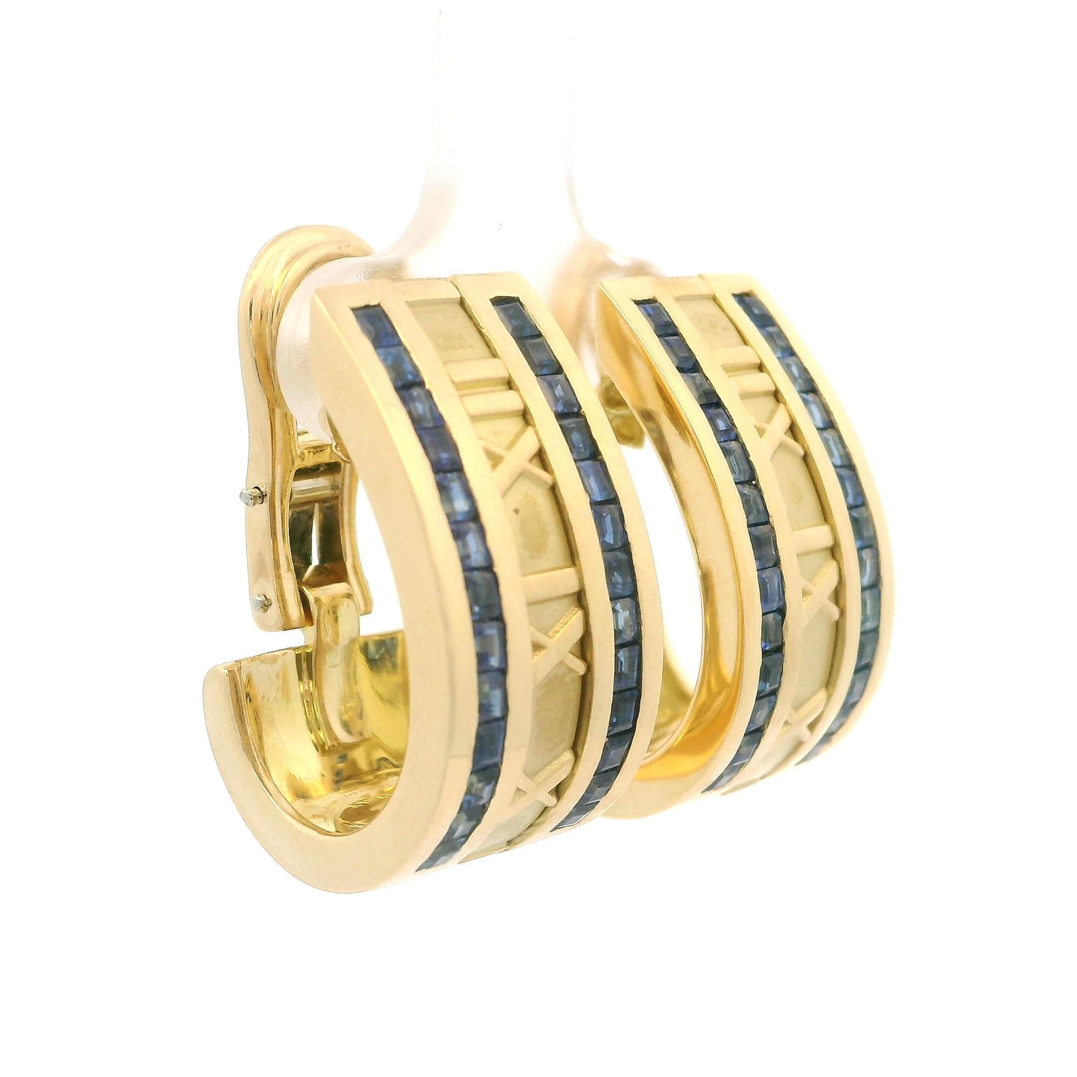 --Stone(s):-- 
(52) Natural Genuine Sapphires- Calibre Square Step Cut - Channel Set - Gorgeous Blue Color - 1.75mm each (approx.)

Material: Solid 18K Yellow Gold 
Weight: 26.44 Grams
Backing: Swivel Posts w/ Omega Closures (pierced ears are Not