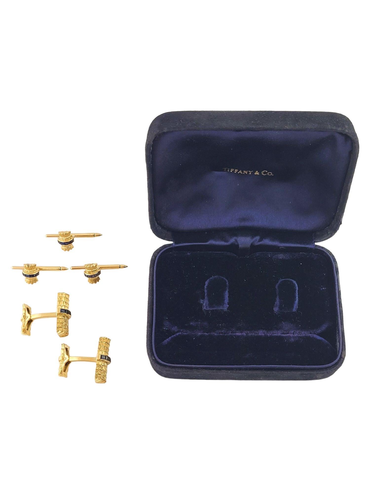 This beautiful set of gold cufflinks and studs by designer Tiffany & Co. are decorated with gorgeous blue sapphires for an amazing look!

Cufflinks-

Size: 23.6mm X 20.2mm X 10.6mm

Weight: 14.78 g/ 9.5 dwt

Hallmark: Tiffany & Co 18K

10 blue