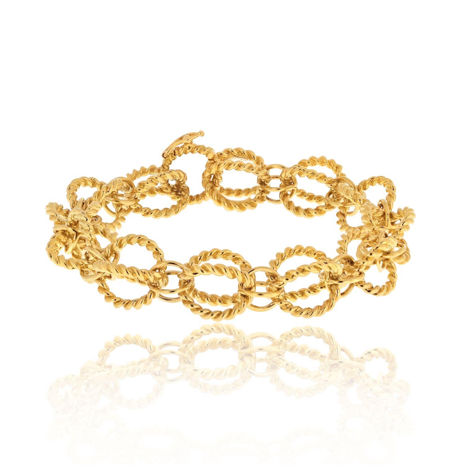 Tiffany & Co. 18K Yellow Gold Schlumberger Circle Rope Bracelet.
Jean Schlumberger’s visionary creations are among the world’s most intricate designs. Ornate twisted links add dimension to this elegant bracelet.

L: 7 inches.
