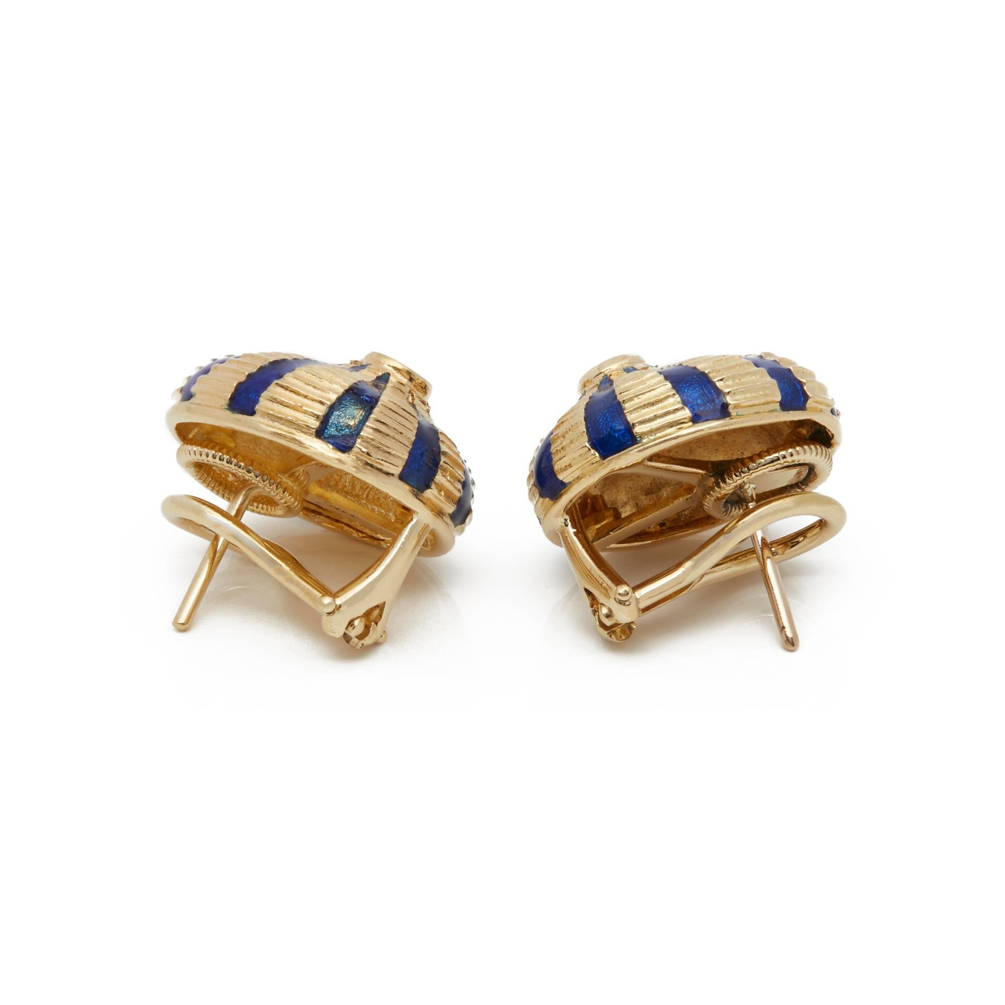 These Earrings by Tiffany & Co are from their Schlumberger Collection and features two Round Brilliant Cut Diamonds in a Rub Over Setting with Blue Enamel Banding, mounted in an 18k Yellow Gold Setting. Complete with Xupes Presentation Box. Our