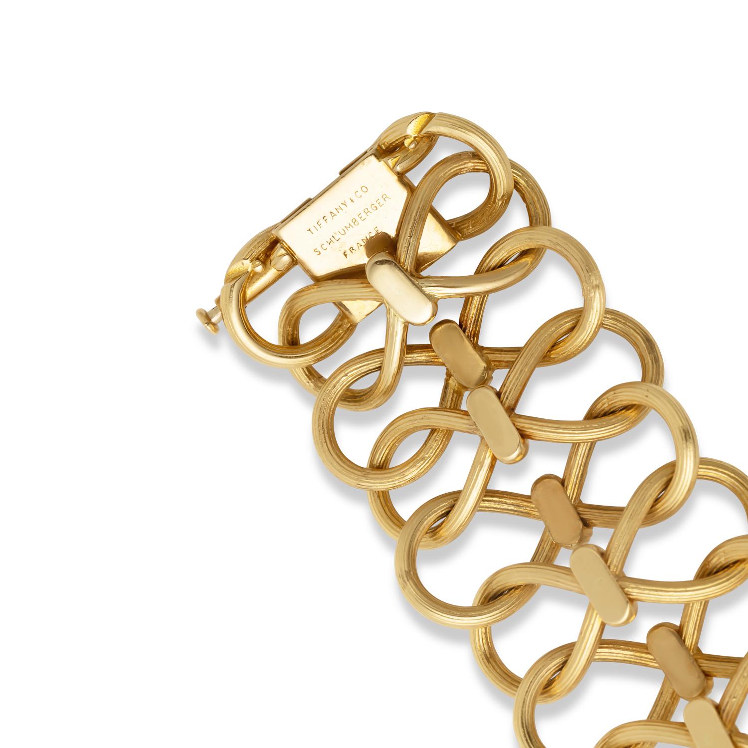 Elevate your wristwear with the timeless elegance of the Tiffany & Co. 18K Yellow Gold Schlumberger Bracelet. Crafted with impeccable artistry, this bracelet features a captivating braided link style that exudes sophistication and charm.

Each link