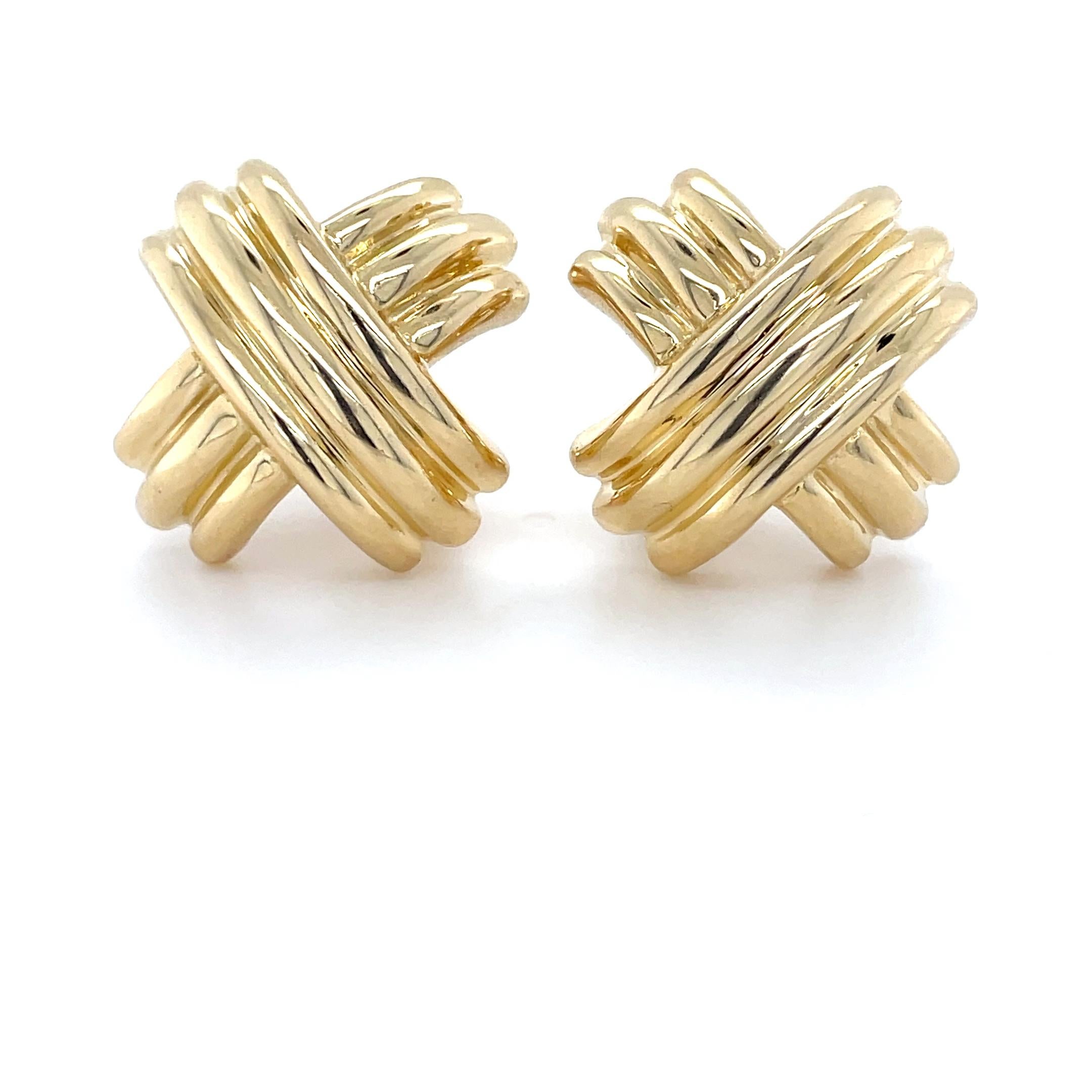These classic earrings by Tiffany & Co. are a part of their Signature X Collection. Crafted in high polished X's these earrings are perfect for both a formal occasion or a casual evening out. With posts and omega clip backings

Measurements: 1 x 1