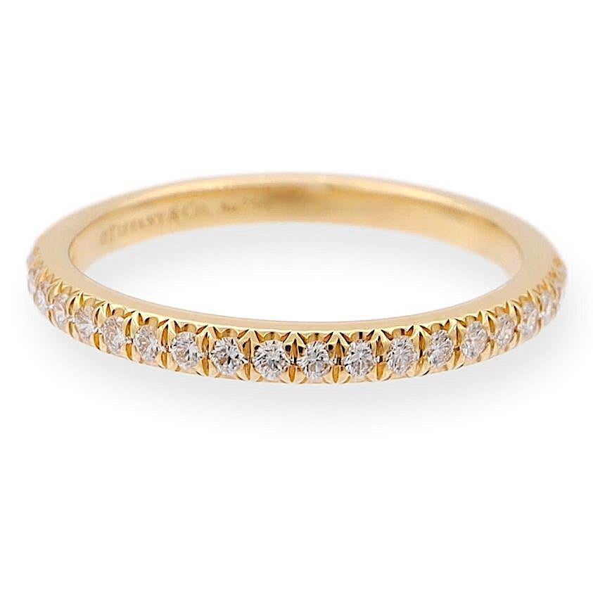 Tiffany & Co. Wedding/Anniversary Half-Band ring from the Soleste collection  finely crafted in 18K yellow gold with 22 round brilliant cut diamonds weighing 0.17 carats total weight encrusted in 