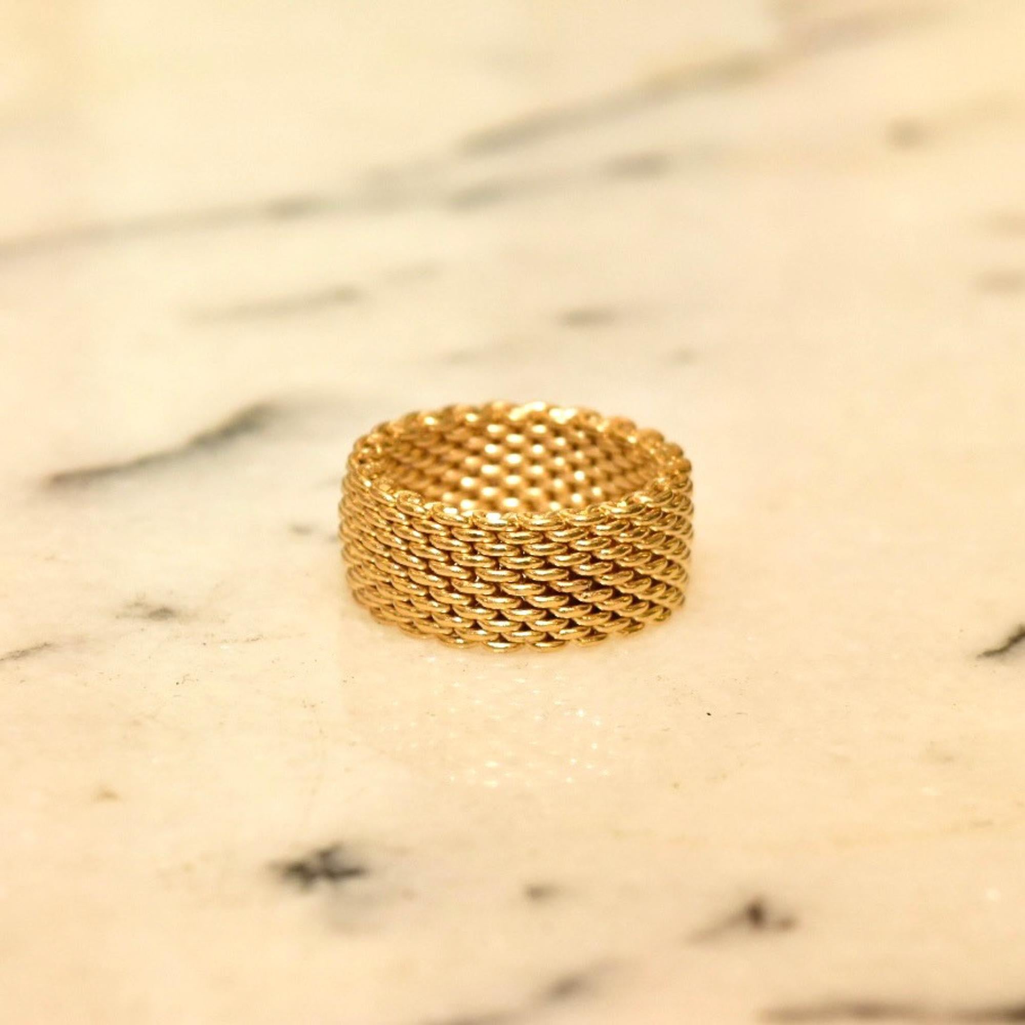 A timeless Tiffany & Co. 18k yellow gold Somerset ring. Features a 10 mm flexible mesh  band comprised of solid gold links just over 2 mm thick. The ring has substantial weight and fits comfortably on a size 8 3/4 finger.

The ring is hallmarked