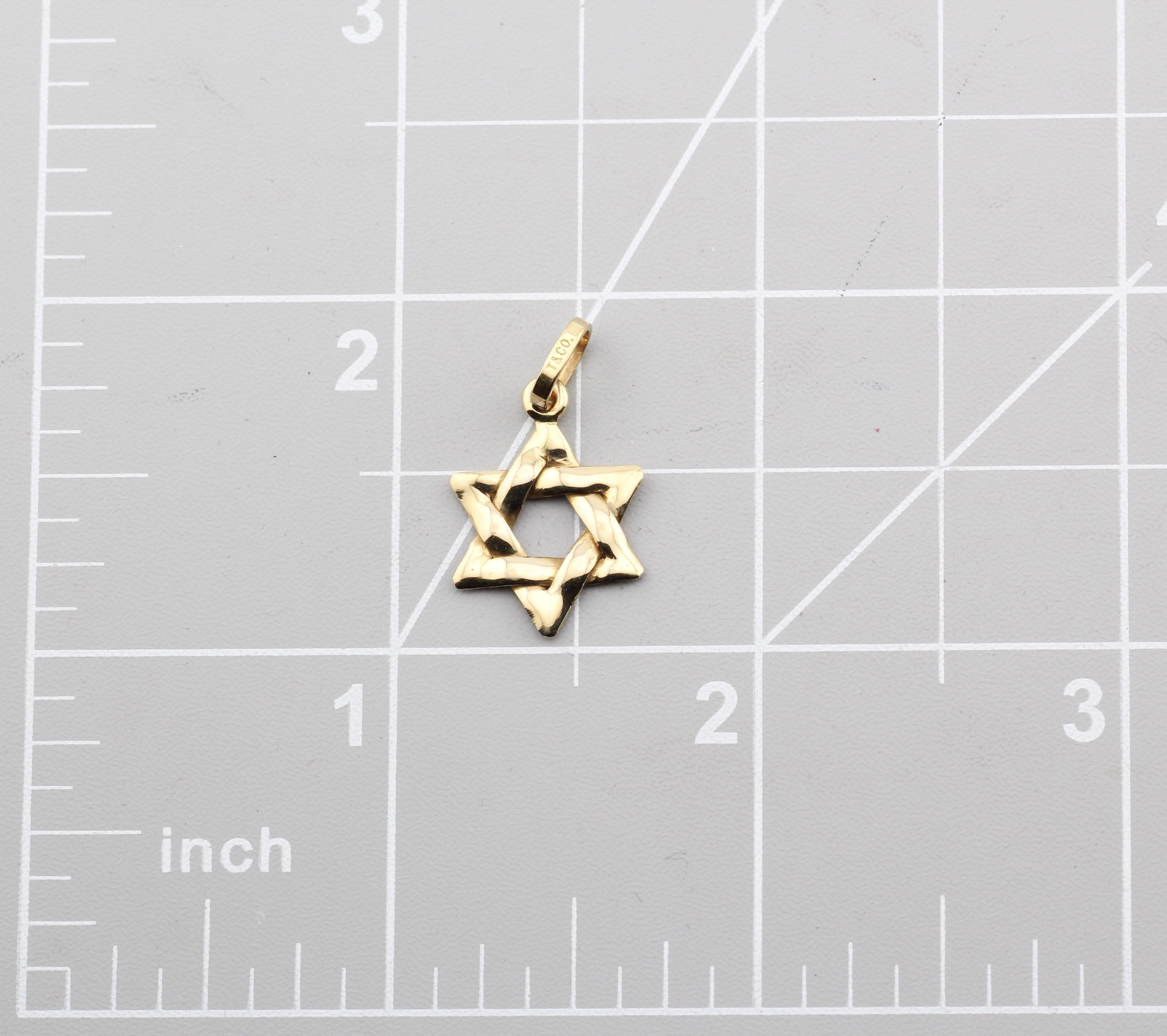 The Tiffany & Co. 18k Yellow Gold Star of David Pendant Charm is a timeless piece that reflects both spirituality and elegance. Crafted from luxurious 18k yellow gold, the pendant features a classic Star of David design, symbolizing Jewish heritage