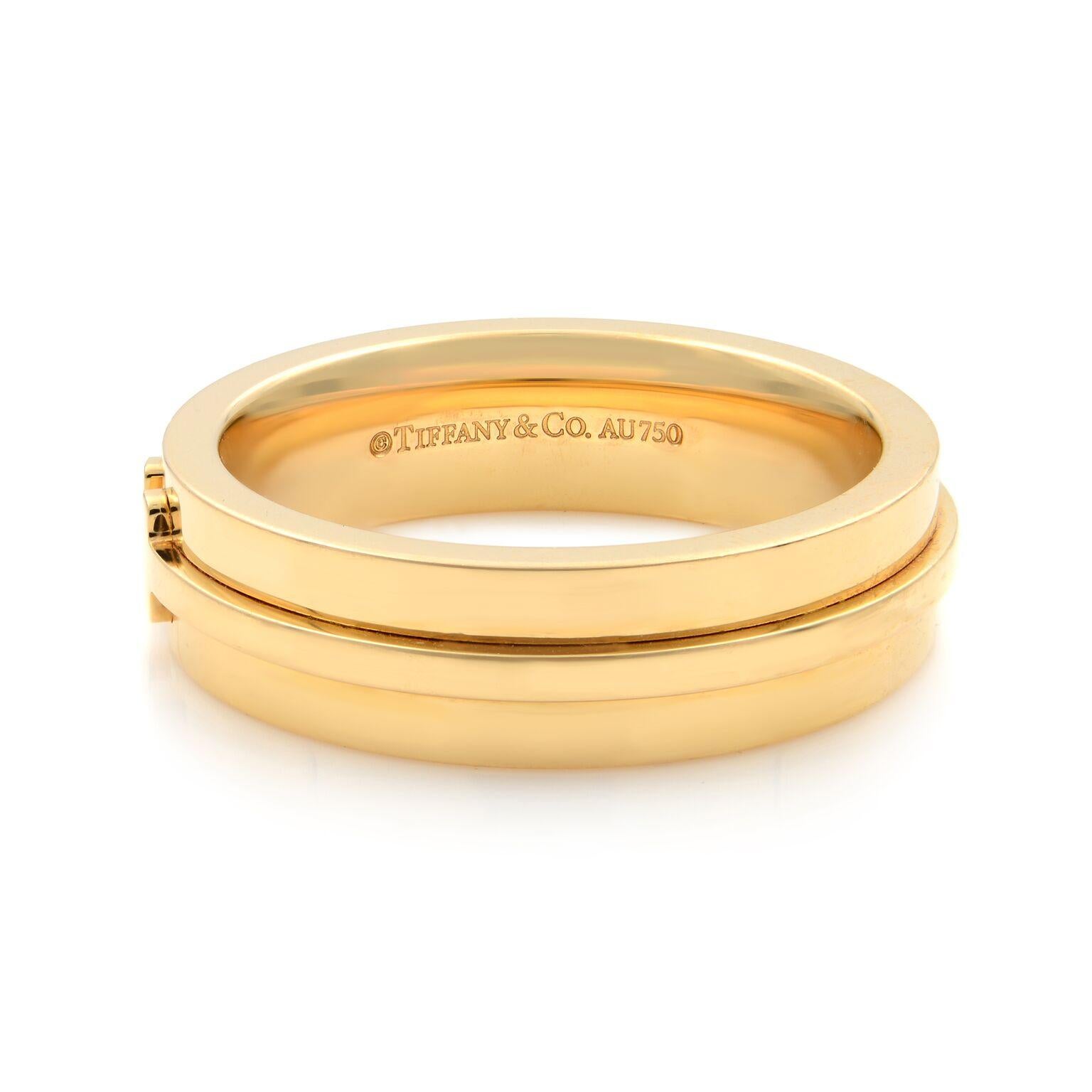 Tiffany & Co T two narrow band. Graphic angles and clean lines blend to create the beautiful clarity of the Tiffany T collection.
Pre-owned, like new 
Material: 18k yellow gold.
Hallmark: Tiffany & Co. Au 750.
Measurement: band is: 5.5mm wide x