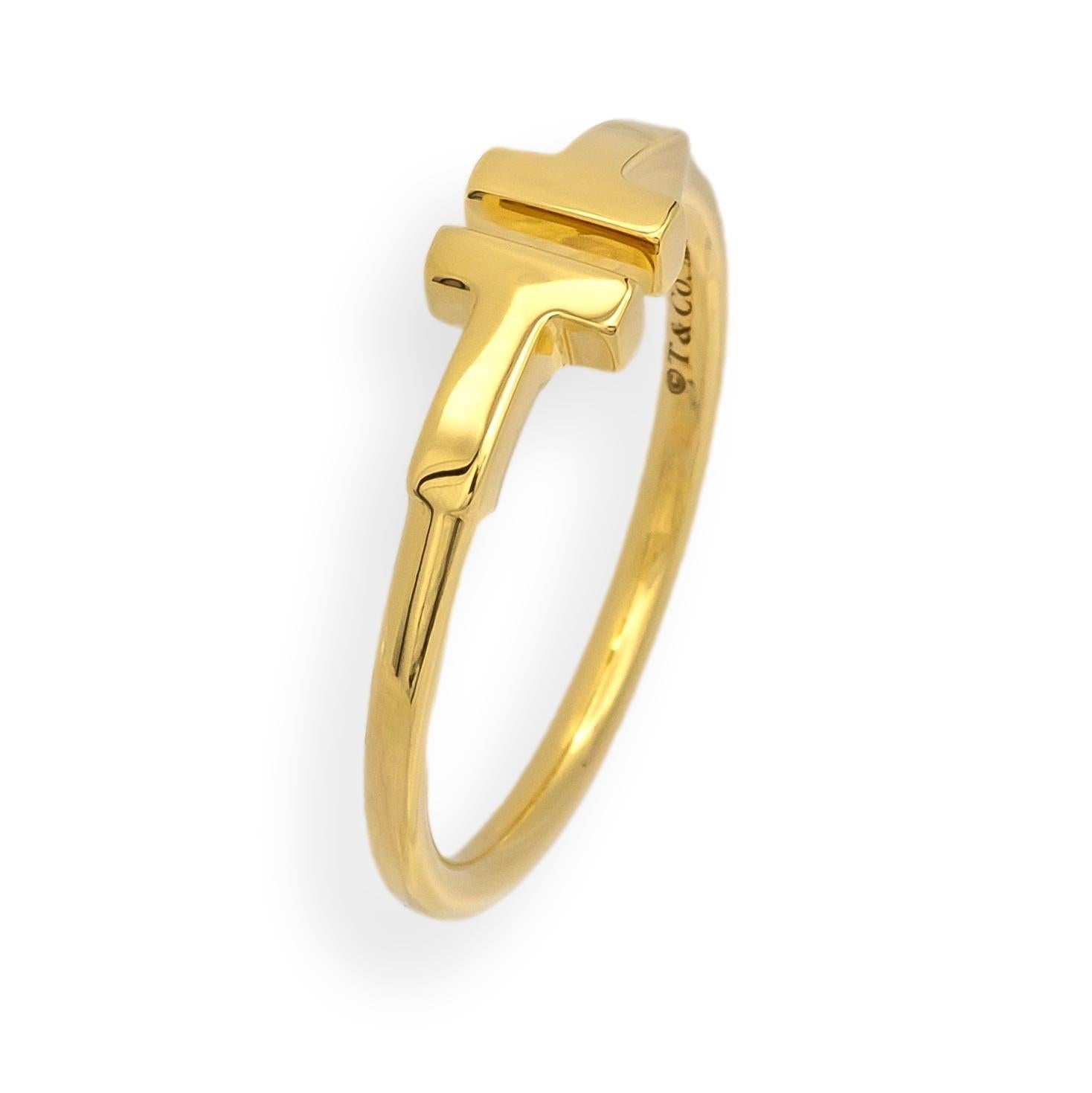 Tiffany & Co. T Wire Ring in 18K yellow gold, size 6.5. This iconic minimalist design features clean, architectural lines with the signature “T” motif. Crafted from solid 18K gold, the band measures approximately 1.7 mm in thickness and is ideal for