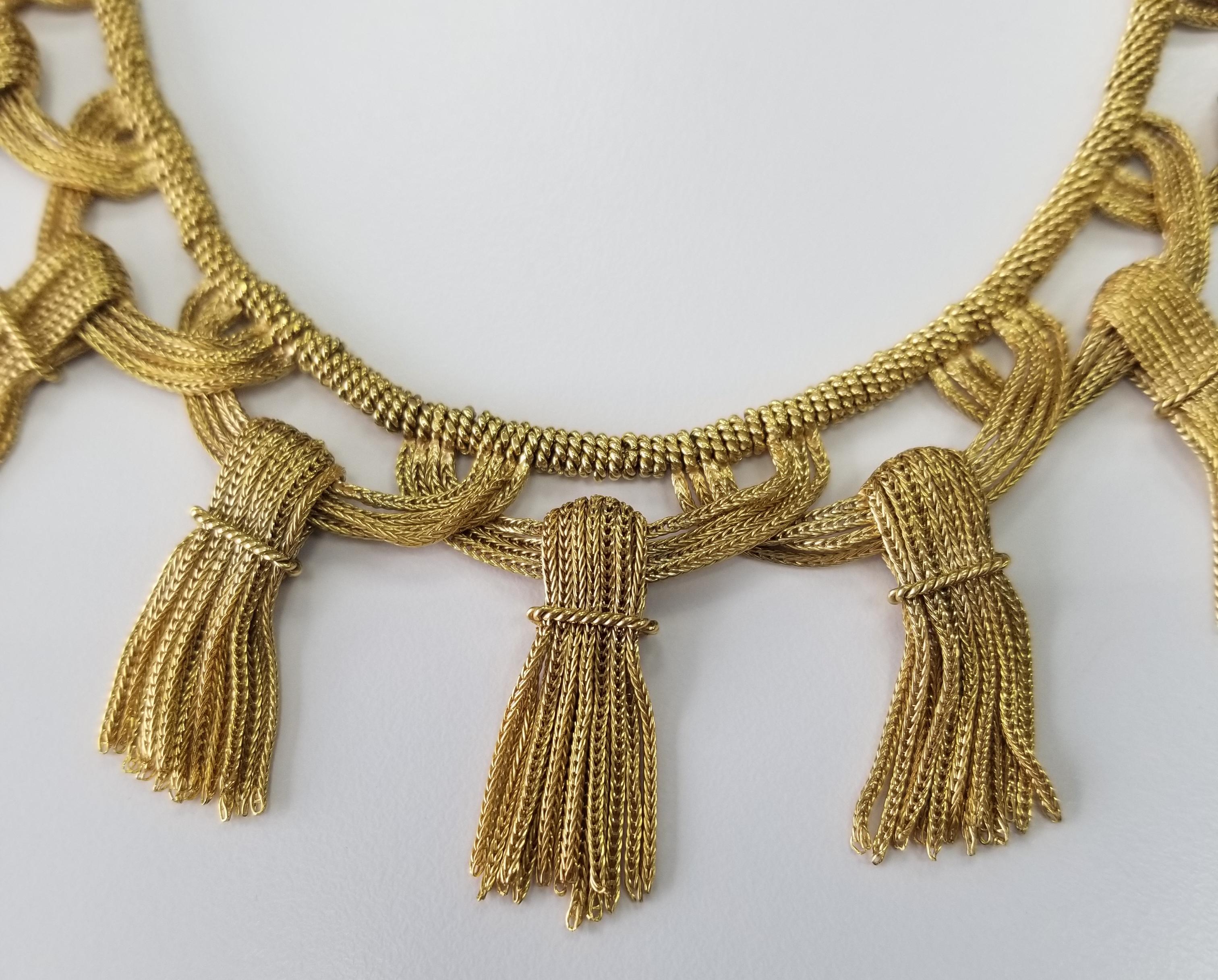 Total Vintage. A stunning 18K gold necklace tassel necklace fastened with a push clasp and safety; measures 15 1/4 inches in length; tassels are 1 1/2 inches long; ; total weight 128.5 g. Tiffany inspired . Stamped: 18K. The piece lays perfectly on
