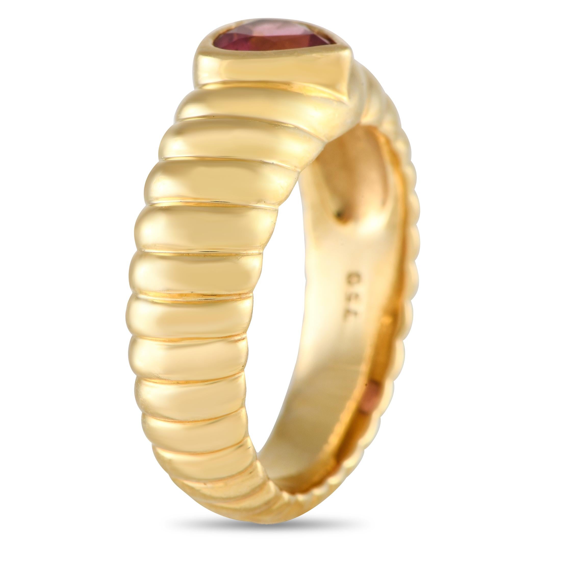 This charming Tiffany & Co. ring will continually capture your imagination. At the center of the textured 18K Yellow Gold setting, a heart-shaped Tourmaline gemstone makes it simply unforgettable. It features a band width and top height both