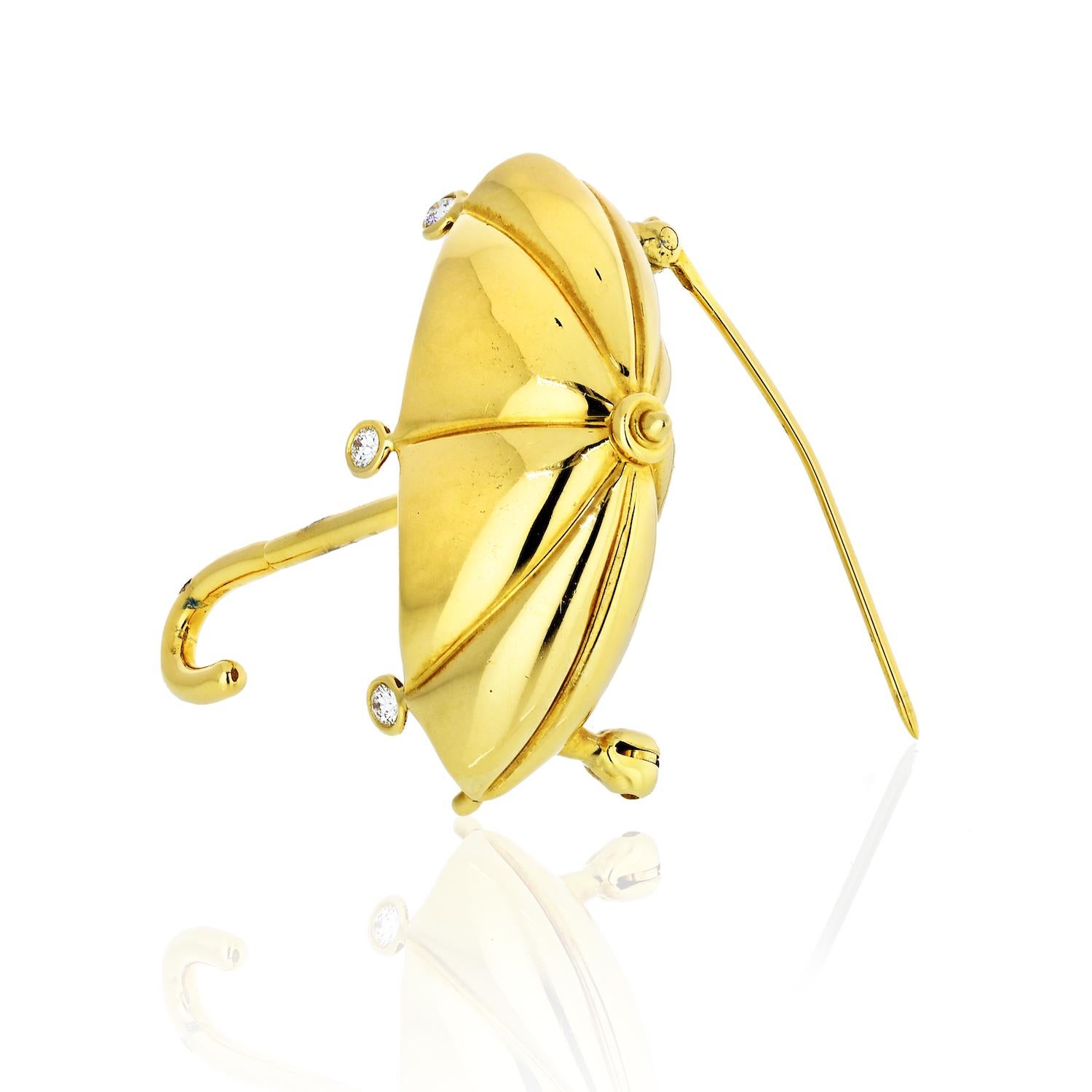 An 18k yellow gold umbrella brooch set with approximately 0.09ctw of G/VS diamonds.

DESIGNER: Tiffany & Co
MATERIAL: Gold
DIMENSIONS: 44mm x 37mm
WEIGHT: 15.2 grams
MARKED/TESTED: Tiffany & Co, 750
CONDITION: Estate
44mmm long.
