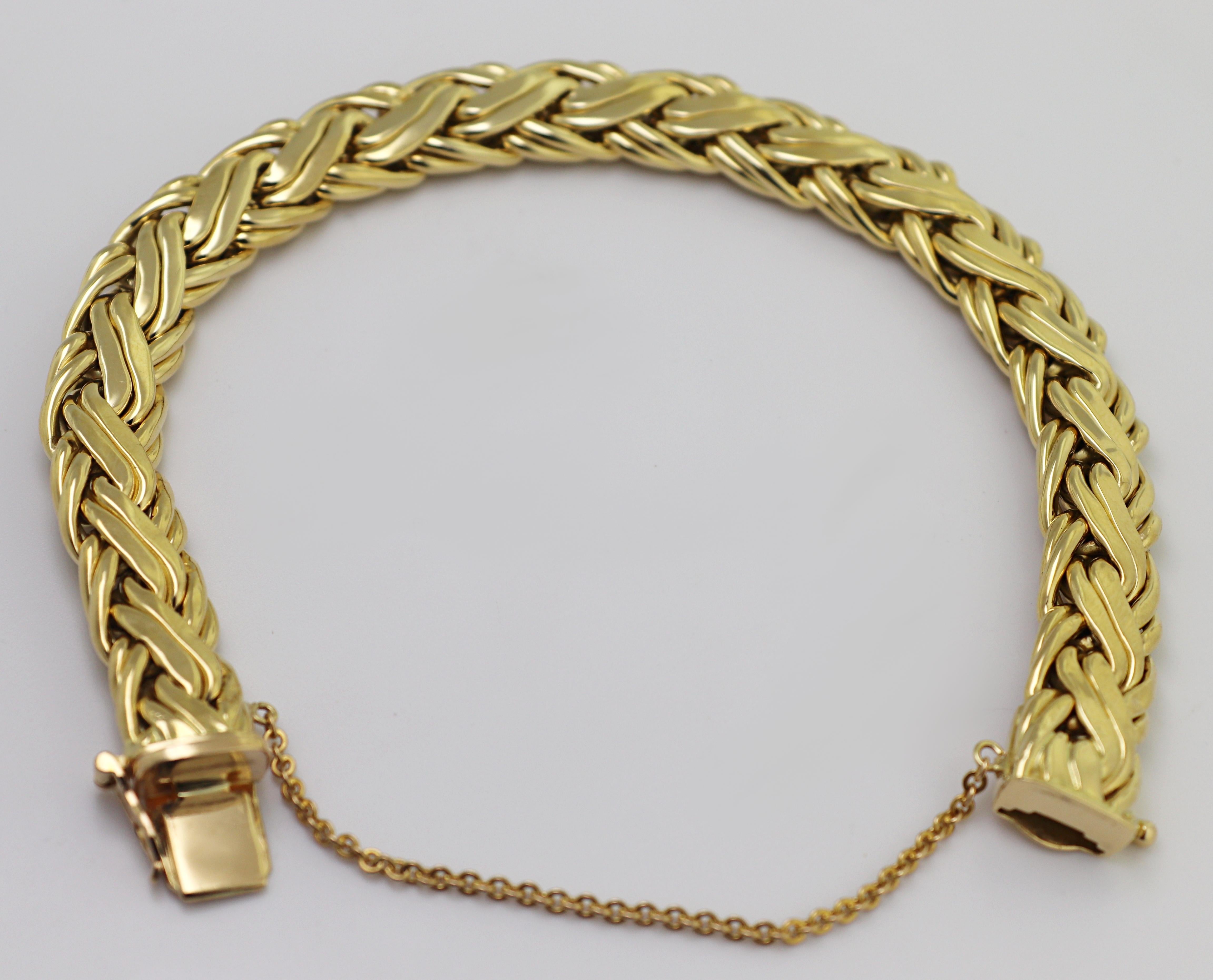 The 18k yellow gold woven link, 9.7 X 4.6 mm, completed by a box clasp,
with figure eight and safety chain, forming a 7.5-inch bracelet, marked
TIFFANY &Co., 750, Weight 33.57 grams.