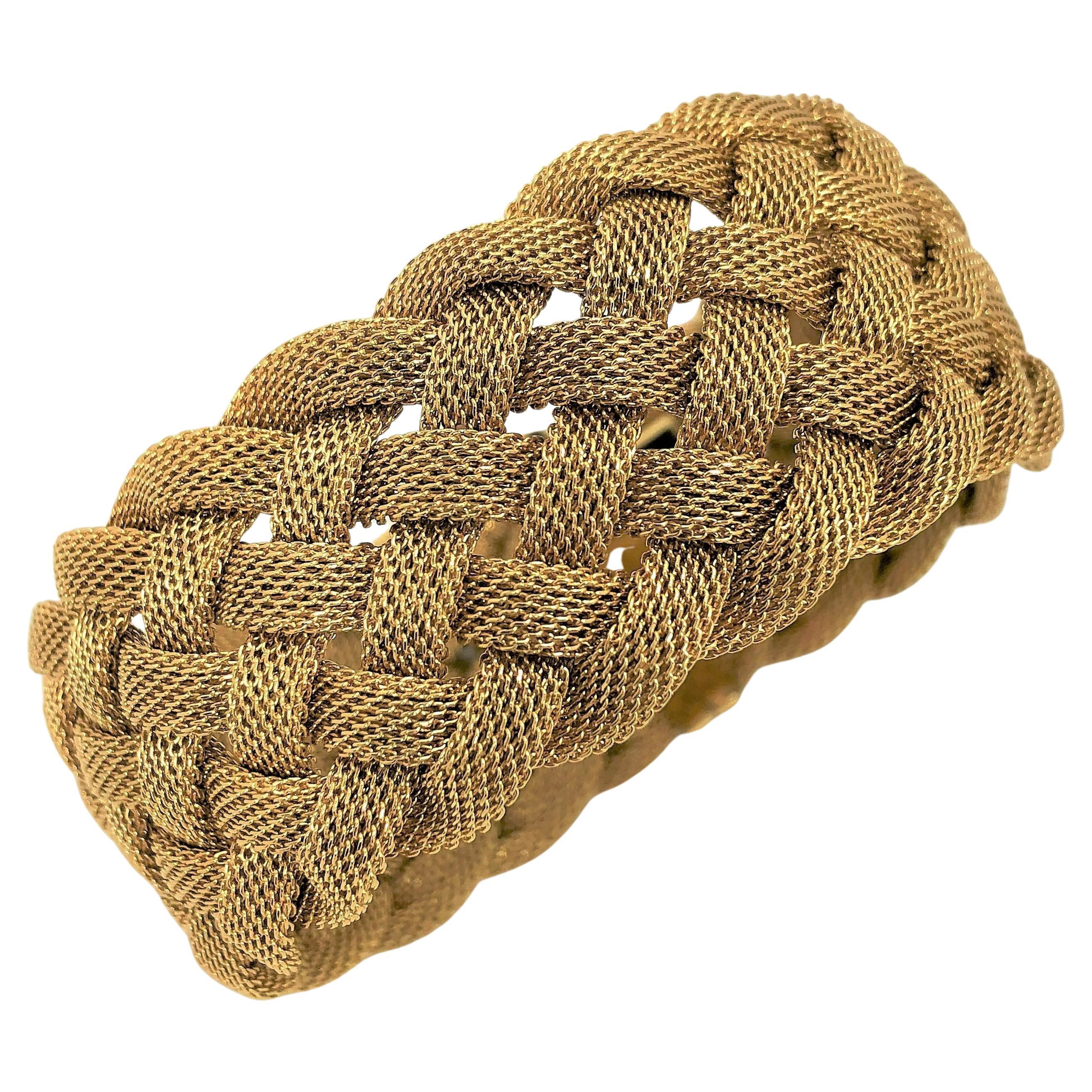 Made by Tiffany & Co late in the 20th Century, this 18K yellow gold mesh bracelet has a curved, bombee look to it. Rather than just laying flat, the 7 curved mesh strands, stand off the arm giving it a more substantial look and feeling. This