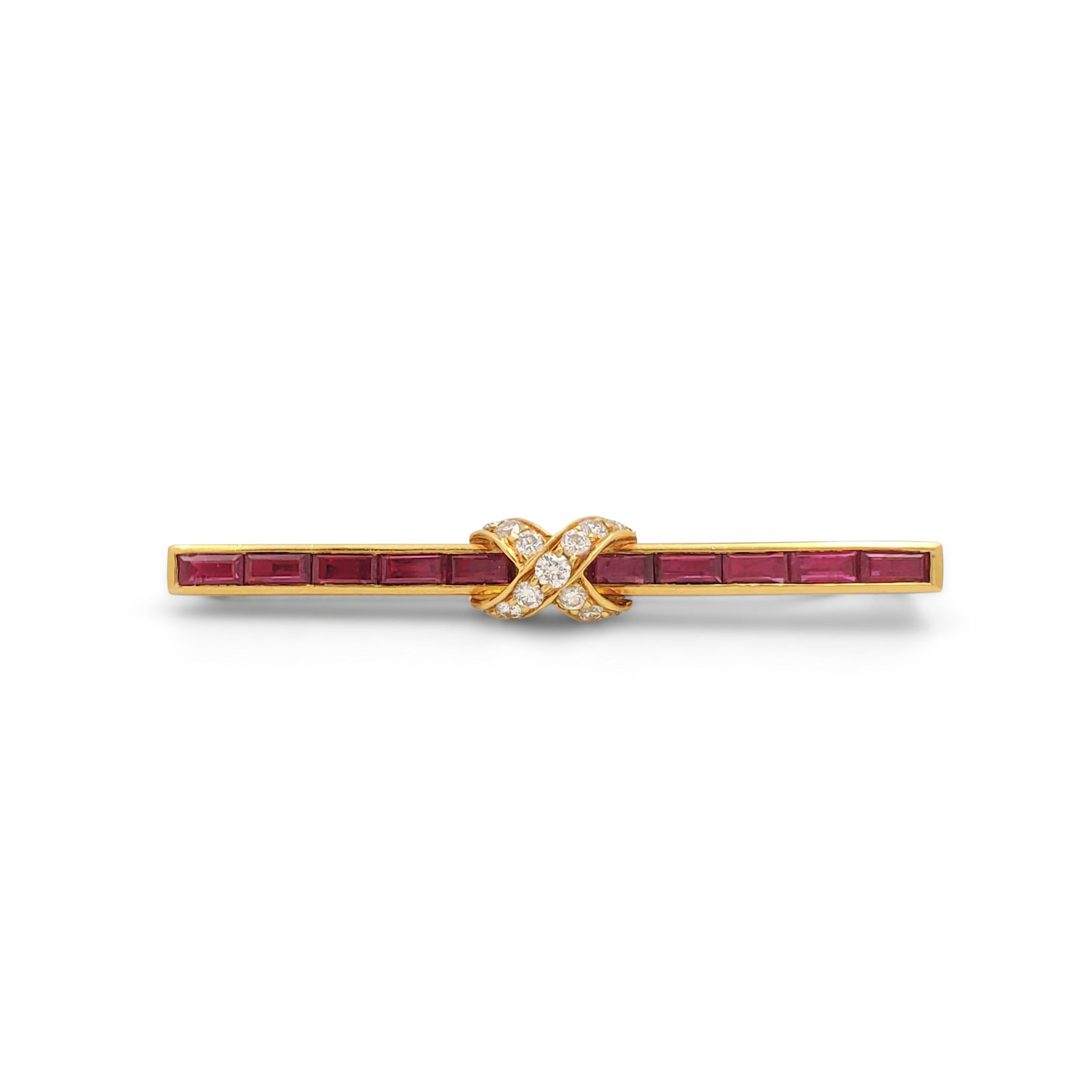Authentic Tiffany & Co. Tie clip crafted in 18 karat yellow gold with a polished finish set with 11 baguettes shaped rubies weighing approximately 0.23 carats each and 13 round brilliant diamonds weighing an estimated 0.50 carats total. The diamonds
