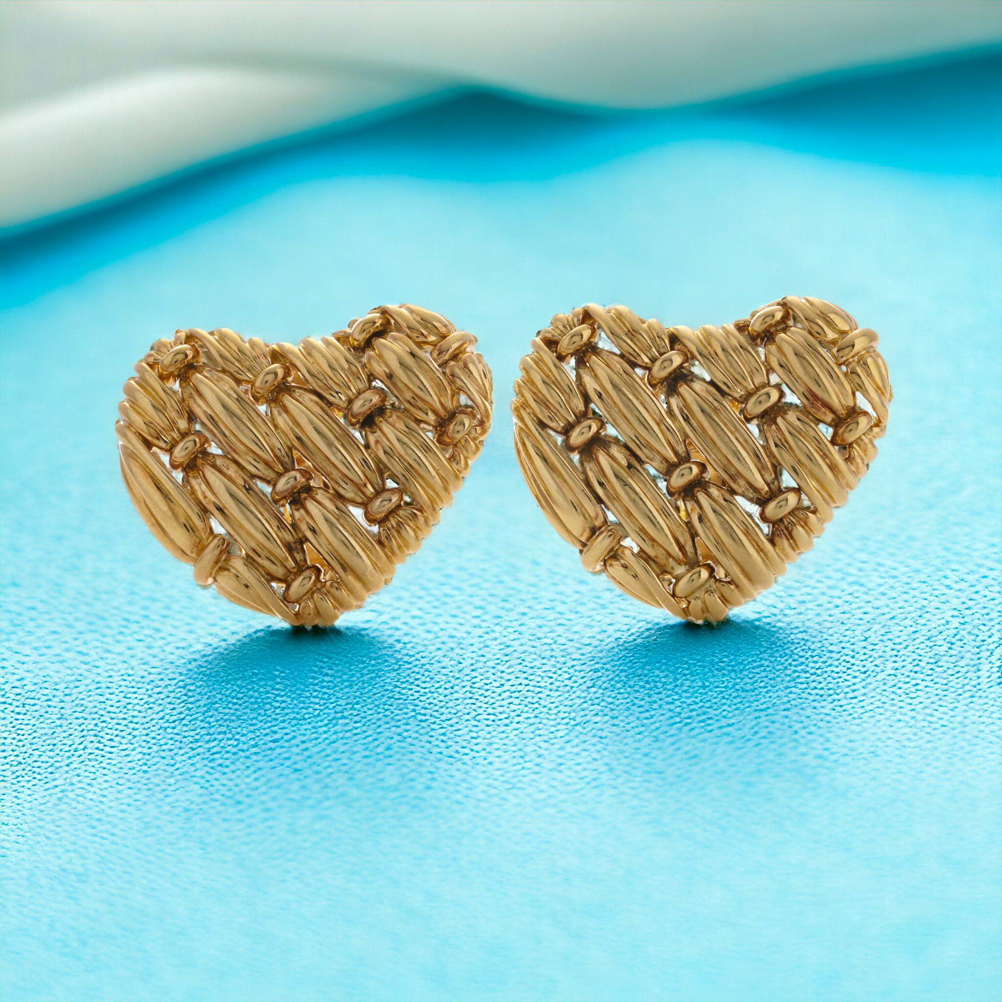 Tiffany & Co 18kt yellow gold ladies woven heart design pair of clip-on earrings. 
Designer: Tiffany & Co. 

Expertly crafted in 1992, these jewels bear the distinguished hallmarks of that era, including the 1992 date and the iconic Tiffany & Co.