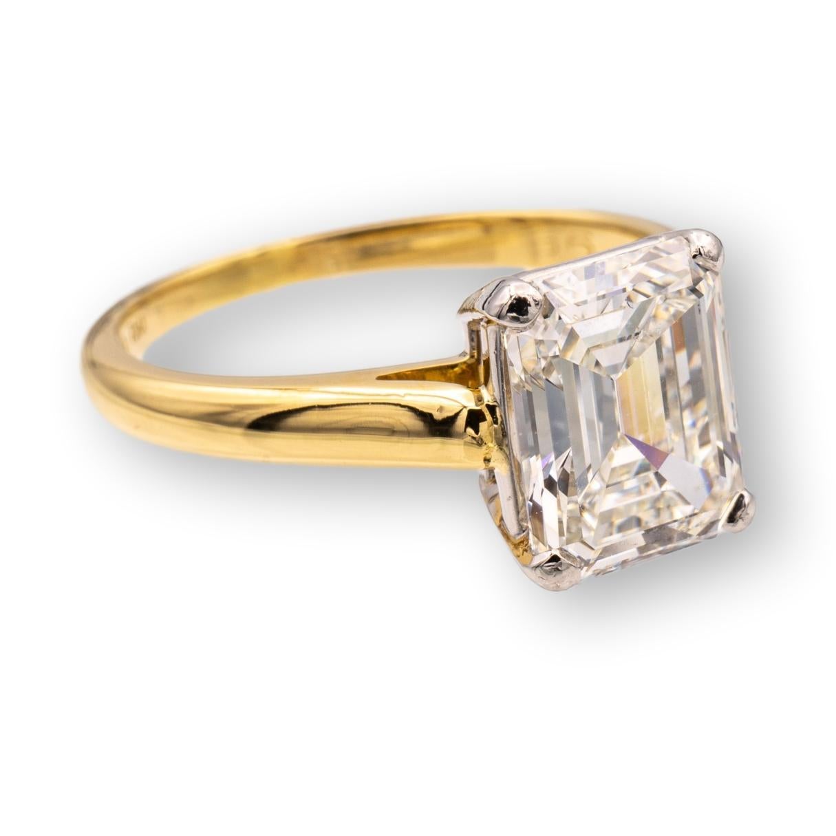 Tiffany & Co. vintage engagement ring finely crafted in 18 karat yellow gold and four prong platinum basket featuring an Emerald cut diamond center weighing 2.04 carats, I color VVS2 clarity. Accompanied by a Tiffany certificate.

RING