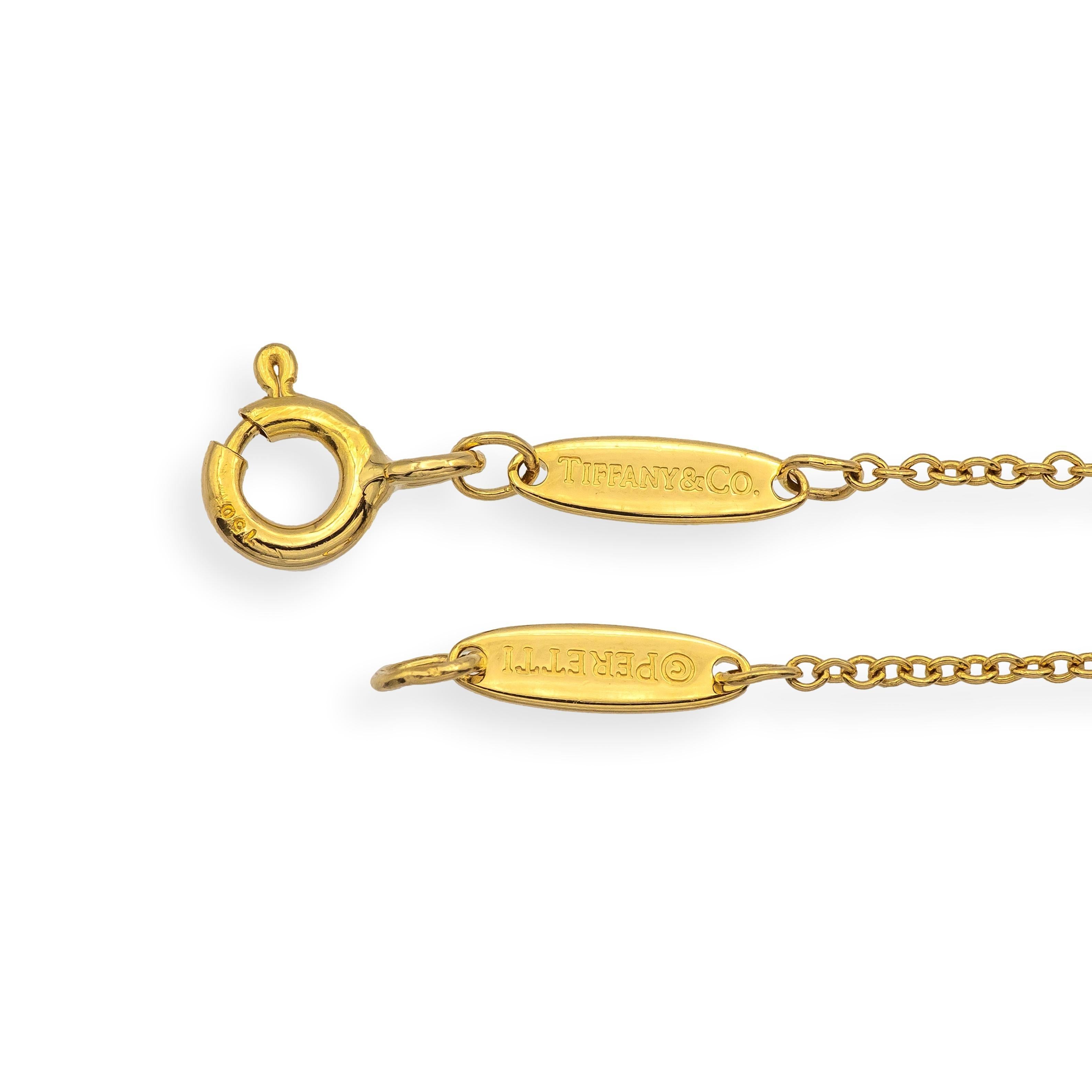 Authentic Tiffany & Co. necklace designed by Elsa Peretti, featuring a single round brilliant diamond bezel-set in 18K yellow gold. Part of the iconic 