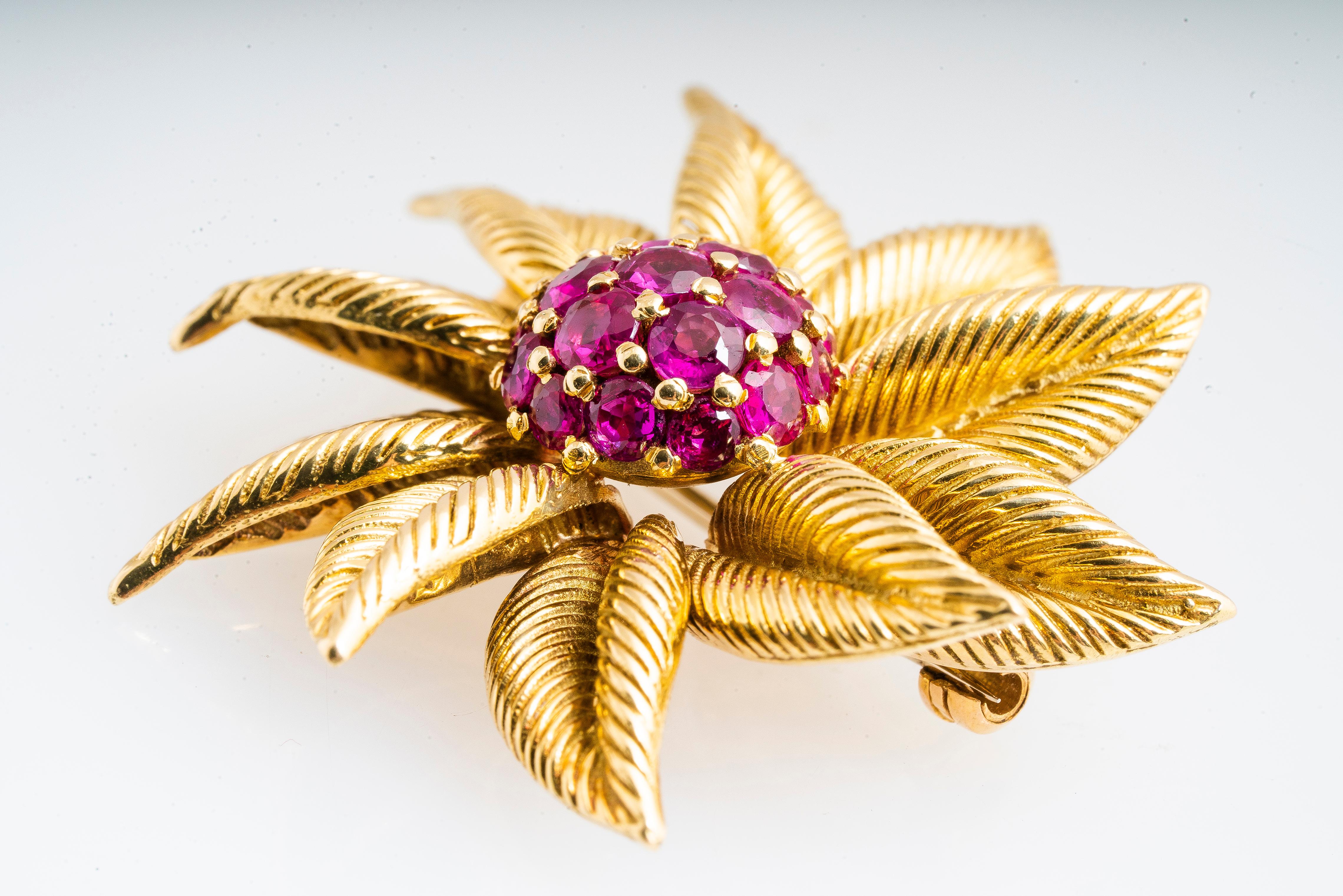 Vintage Tiffany & Co 18k yellow gold and ruby sunburst floral retro brooch.  Approximately 2.60 carat total weight of round clustered rubies.  Brooch is signed 