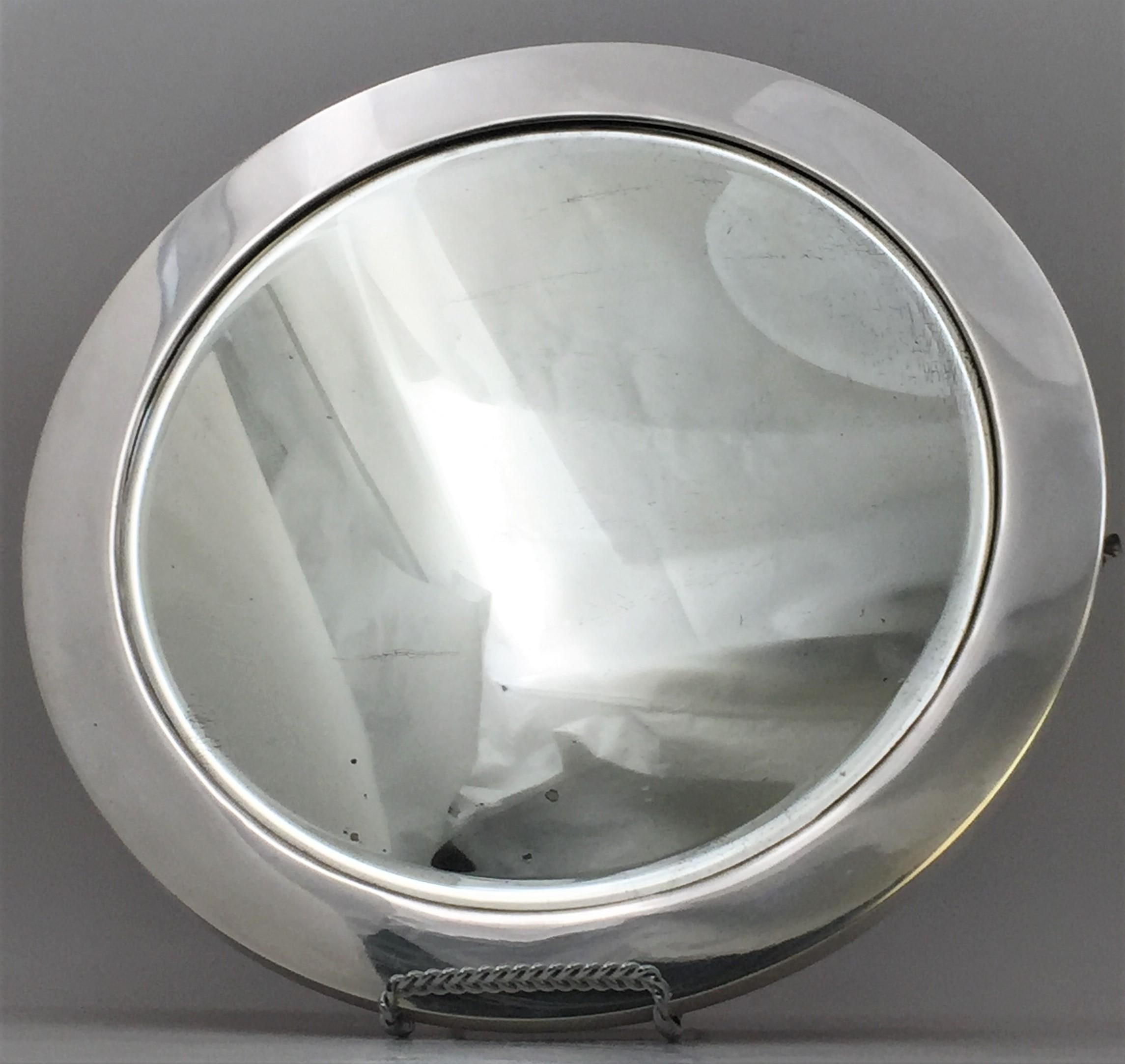 Tiffany & Co. sterling silver table mirror in pattern number 17394 from 1909, in Art Deco style with an elegant geometric design, which may also be used as a vanity tray or display platter. It measures 14 3/4 in. in diameter by 7/8'' in height, has