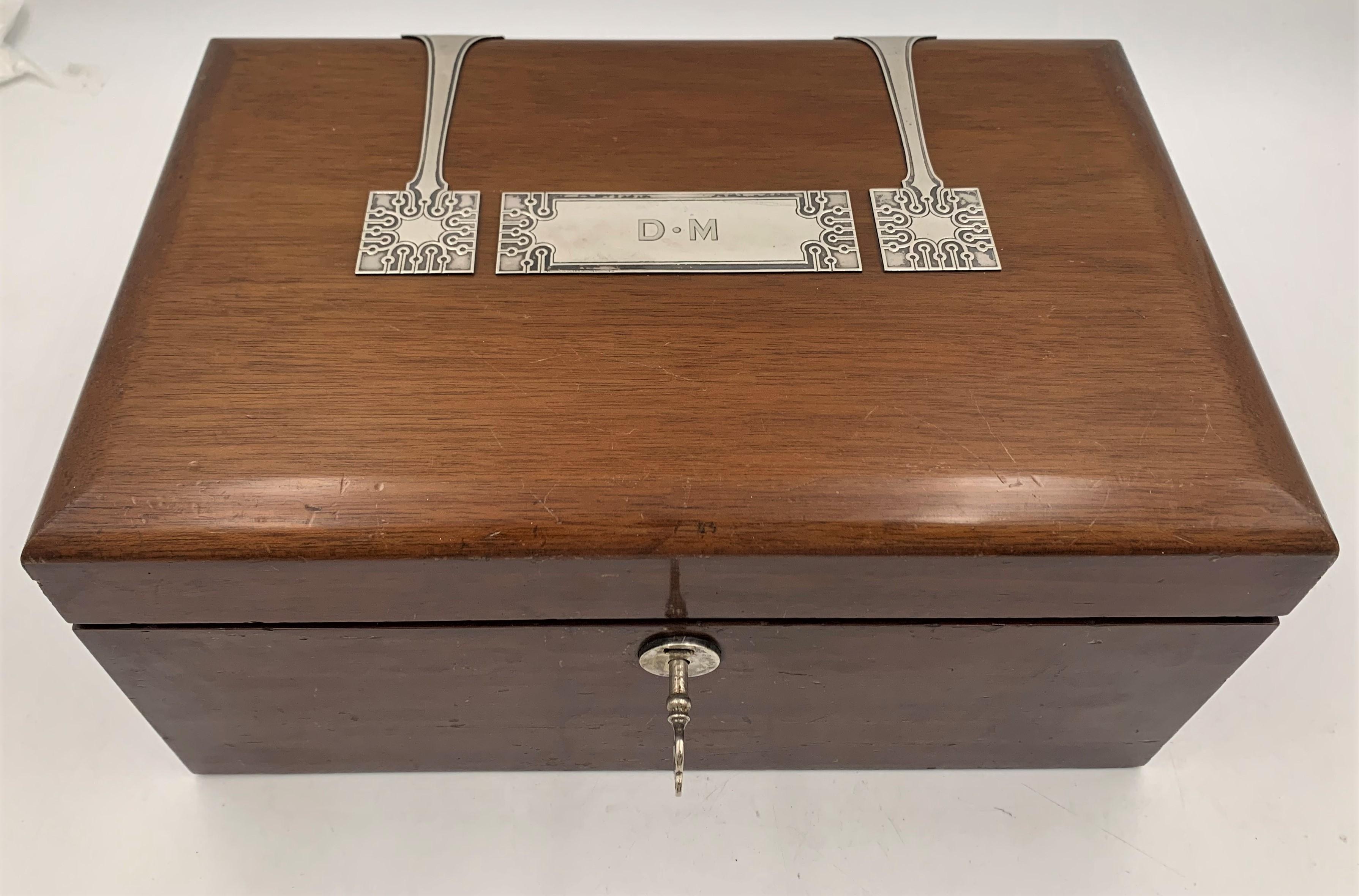 Tiffany & Co. mahogany humidor box in pattern 18529 from 1913 and in Art Deco style with applied sterling silver decorative elements which enhance its appeal. It measures 12 1/2'' by 8'' by 6'' in height, and bears hallmarks and a monogram as shown.