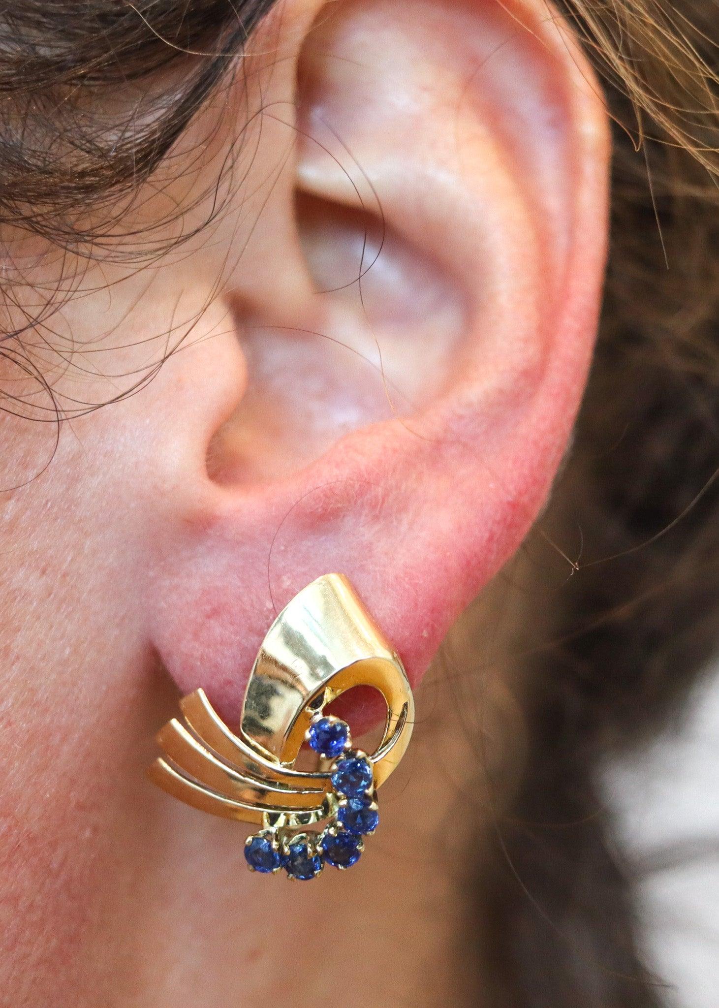 Pair of retro-modern earrings designed by Tiffany & Co.

This is a beautiful pair of retro-modernist earrings, created in New York City by the jewelry house of Tiffany & Co, back in the 1940. The earrings have been crafted as a left and right pair,